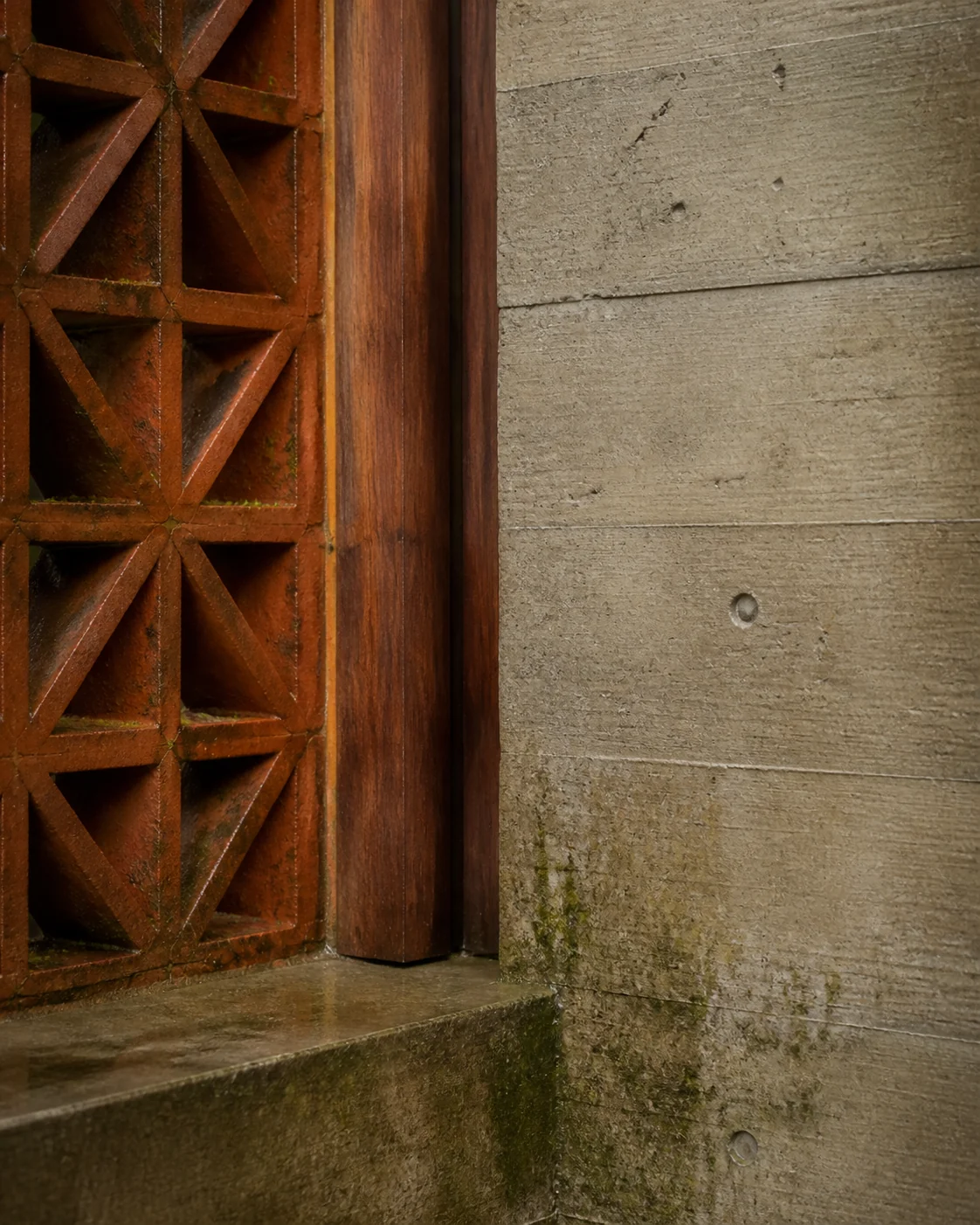 Handmade brick screen, teak reveal and board-formed concrete after rain.