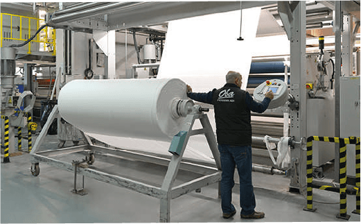 Two people sit across a table in a stylish room with red velvet walls and a large red pendant light. The mood is intimate and modern.