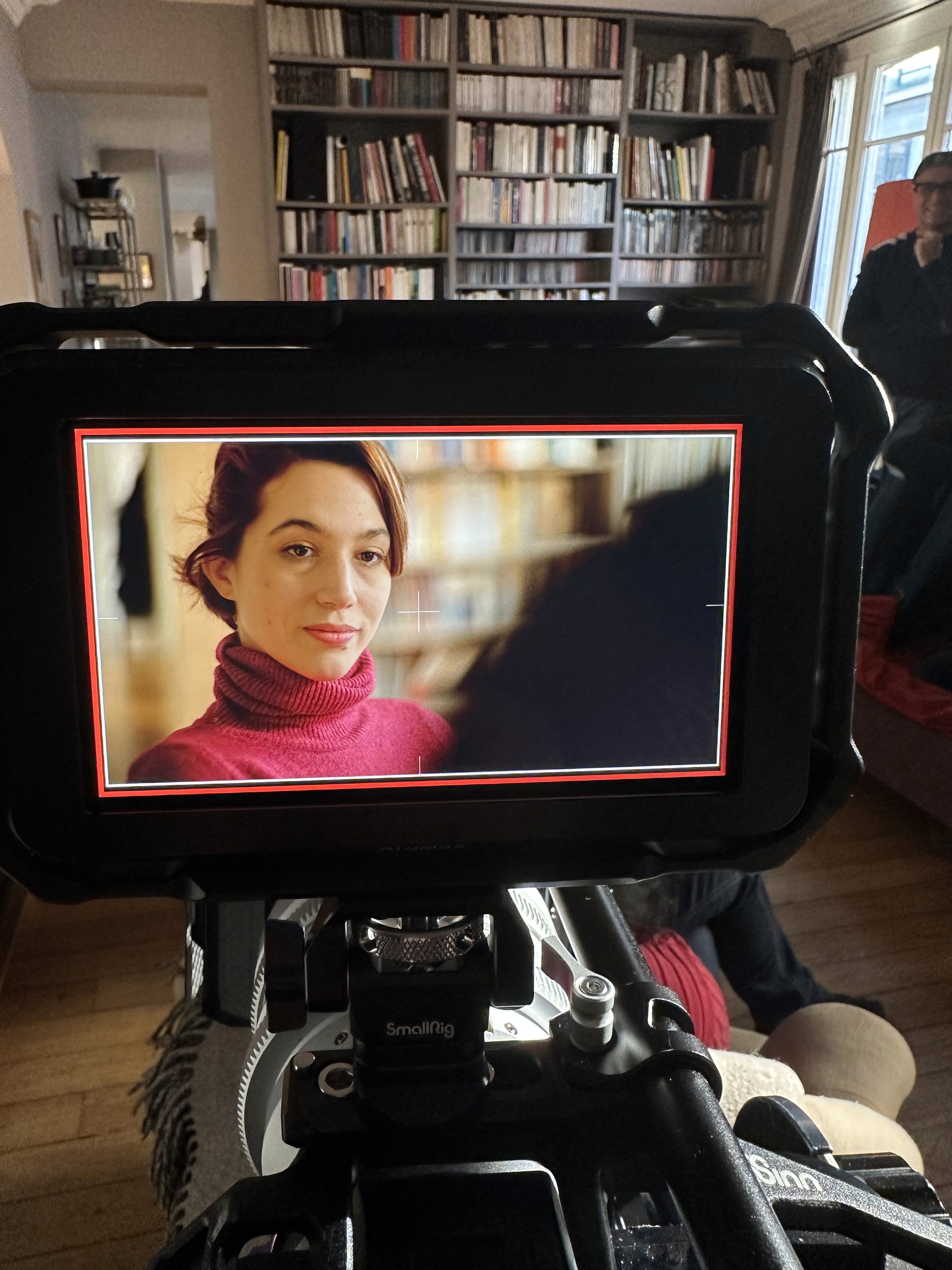 Woman in pink leather jacket crouching outdoors at night