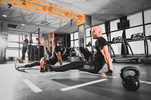 People training together in a modern gym during a high-intensity session