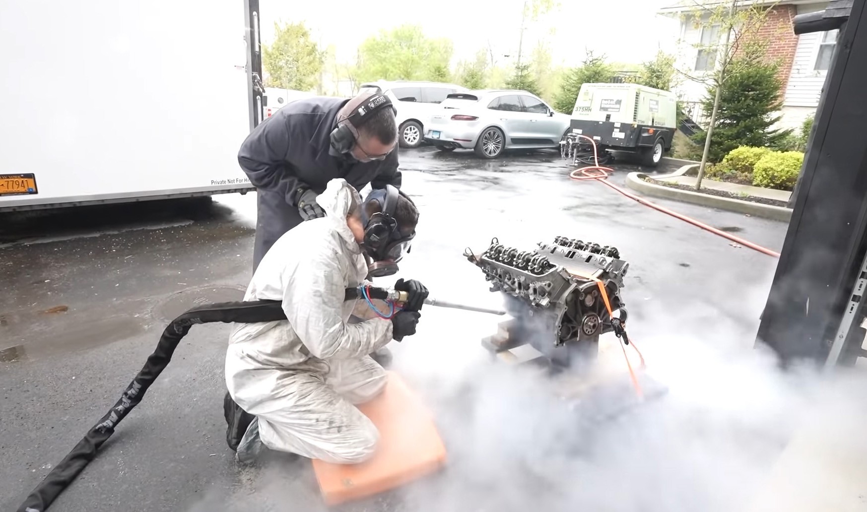 gray vehicle being fixed inside factory using robot machines