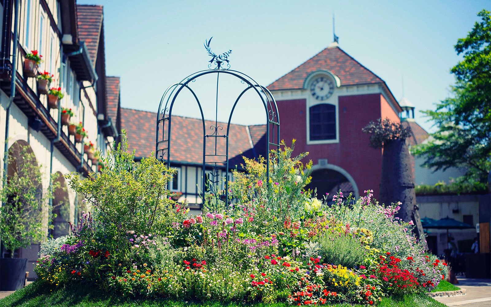 Kobe Nunobiki Herb Gardens with colorful flowers and a scenic building backdrop.