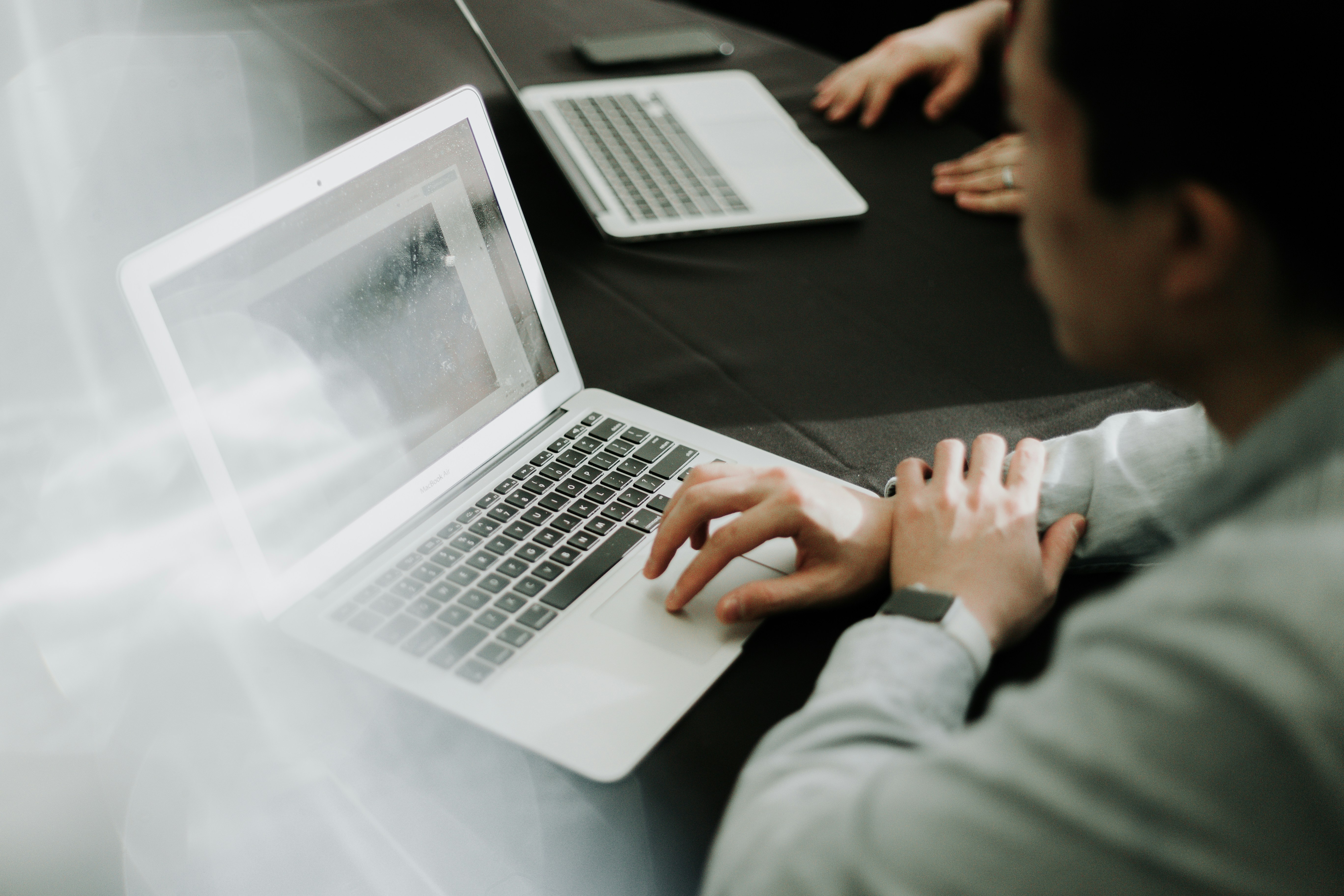 man designing Product Detail Page on a laptop