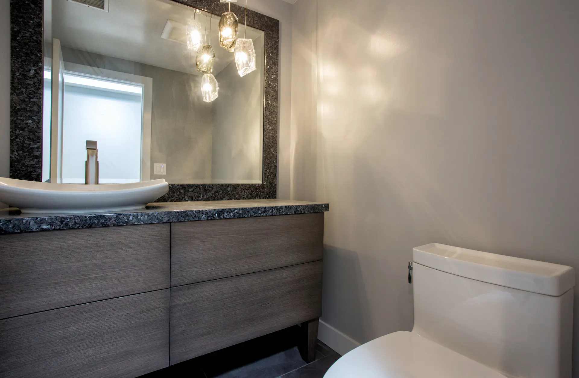 Modern kid's bathroom featuring a vessel sink, textured backsplash, and stylish lighting in Costa Mesa Remodel. Photo by Chris Darnall.