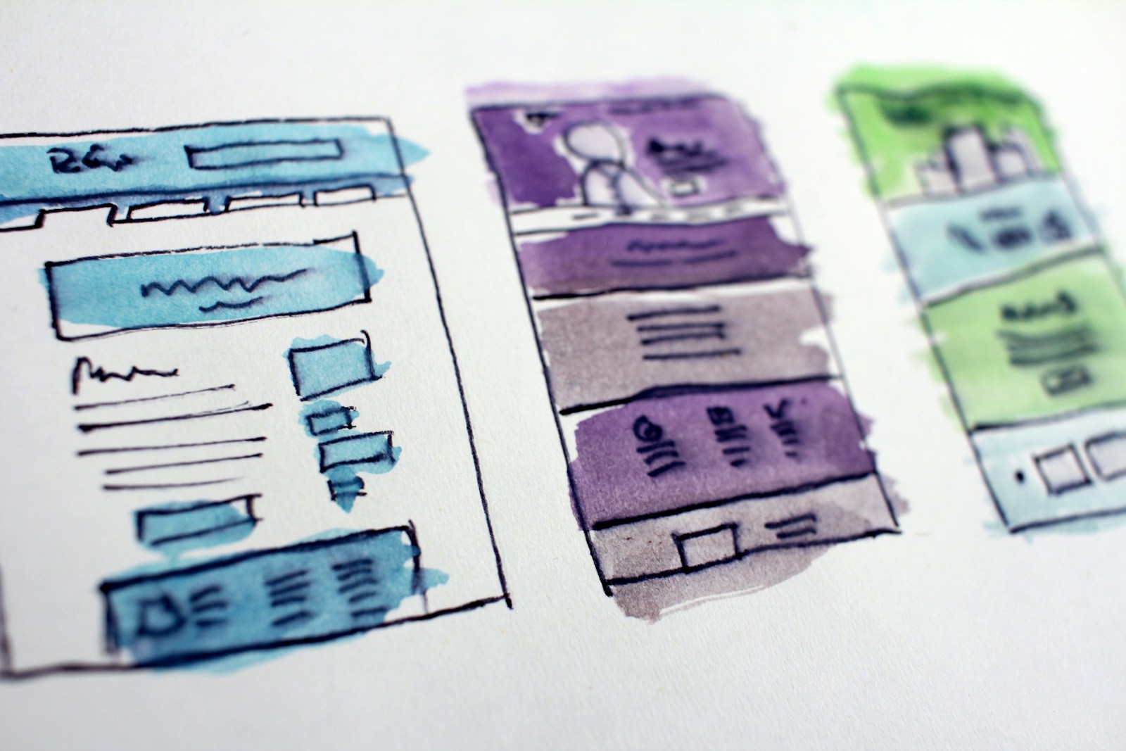 Watercolor wireframe sketches of website layouts