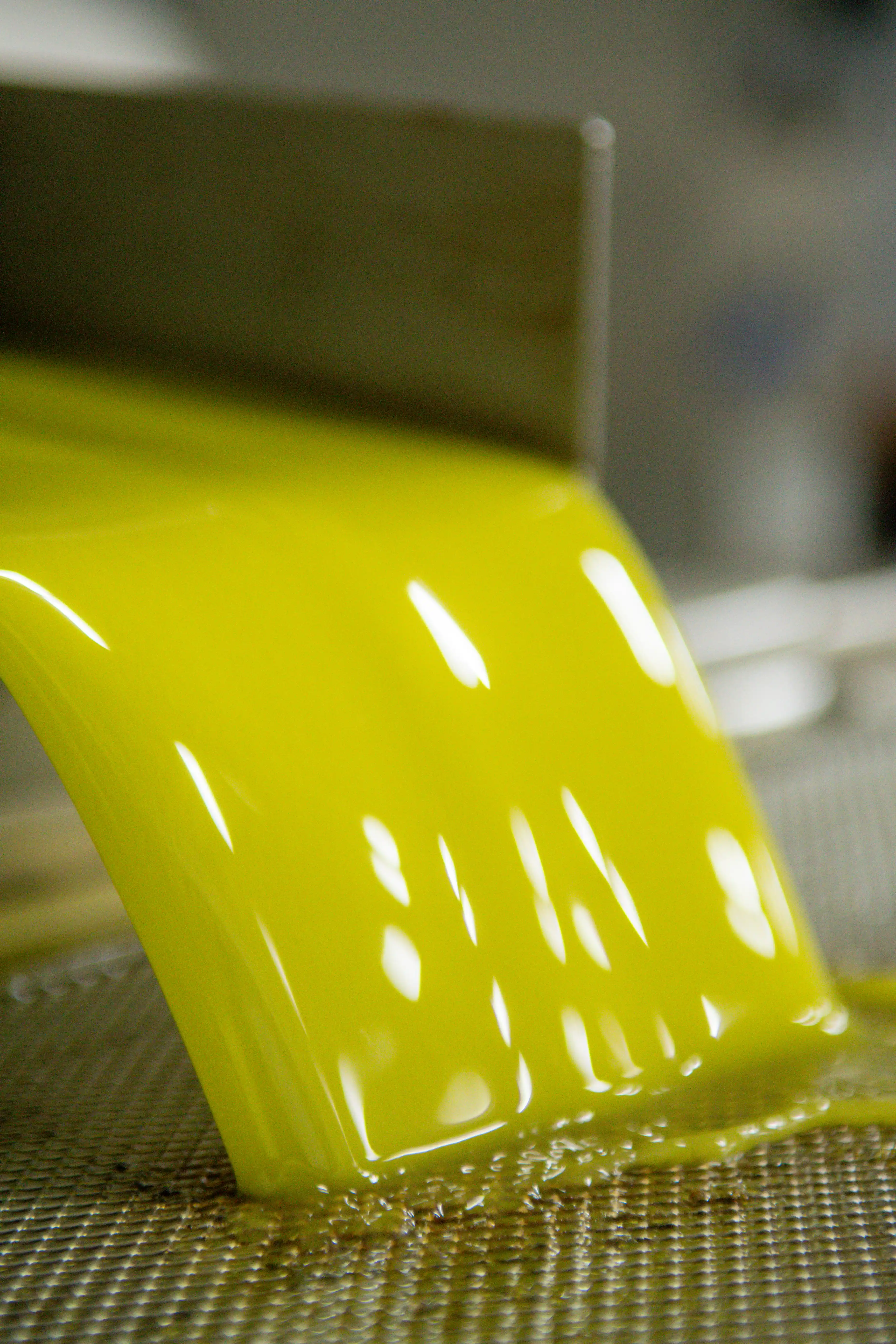 Fresh extra virgin olive oil from Koroneiki variety olives during extraction at Fountas mill in Filiatra, Messenia.