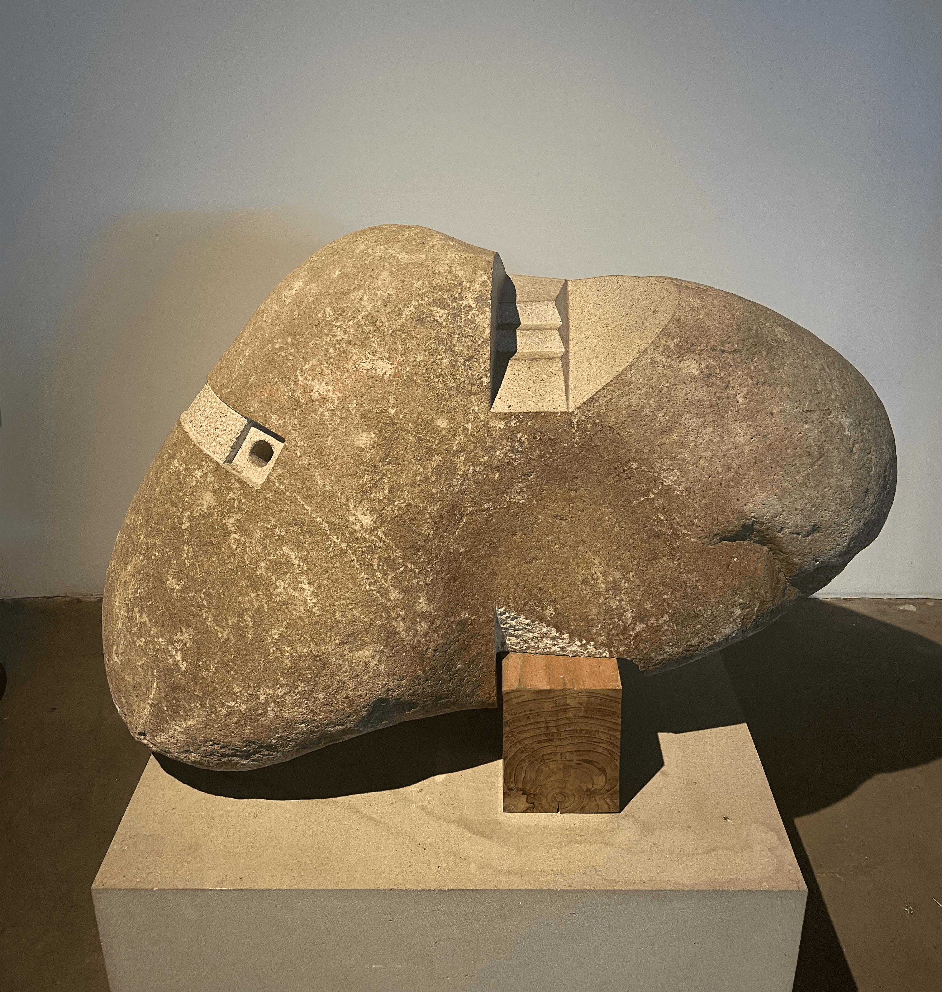 Isamu Noguchi granite sculpture with geometric incision and wooden base, The Noguchi Museum, Astoria New York