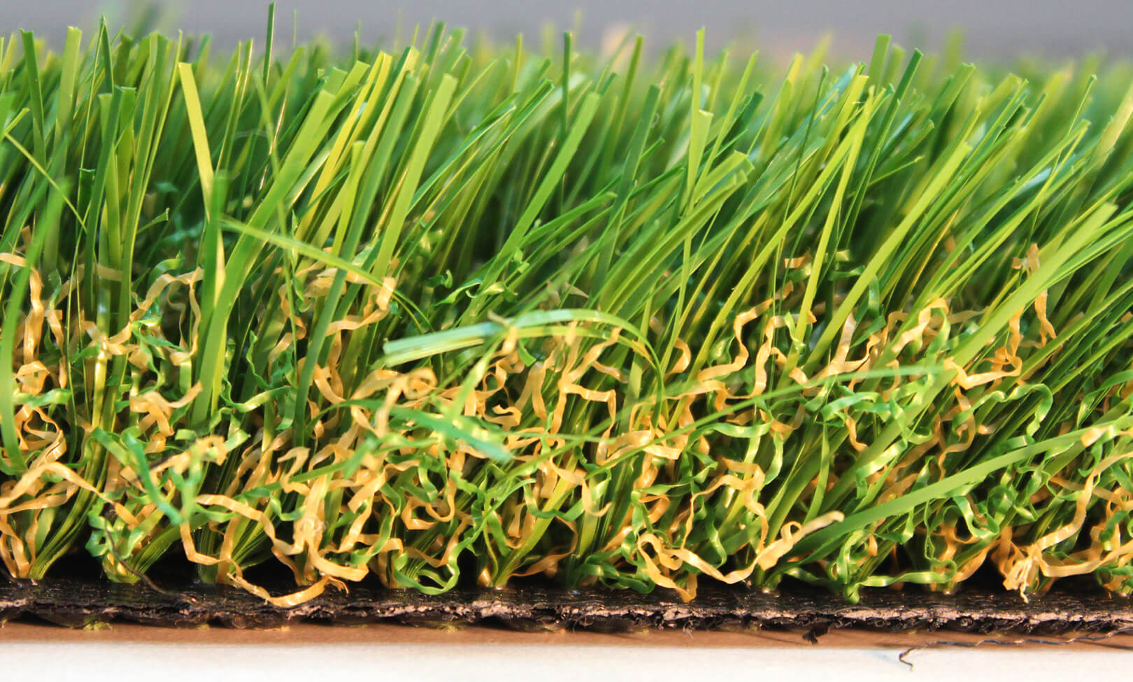 This close-up image of AGL Grass North's Saratoga 60 shows why it is so popular. Its primary fiber color combines field green, olive green, and jute thatching.