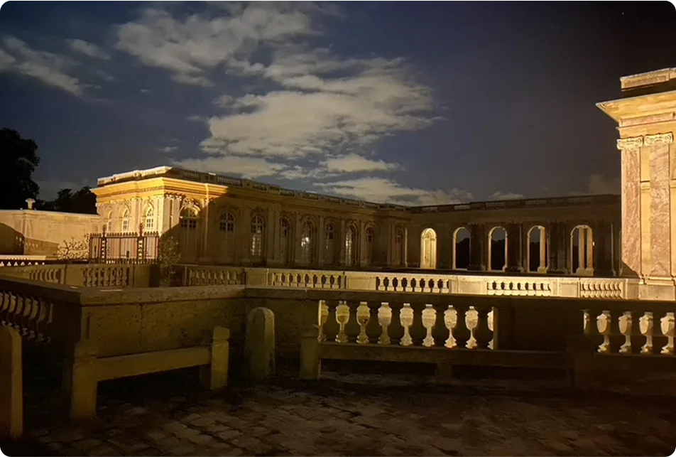 Historic building illuminated at night under a cloudy sky, symbolizing timeless leadership and reflection