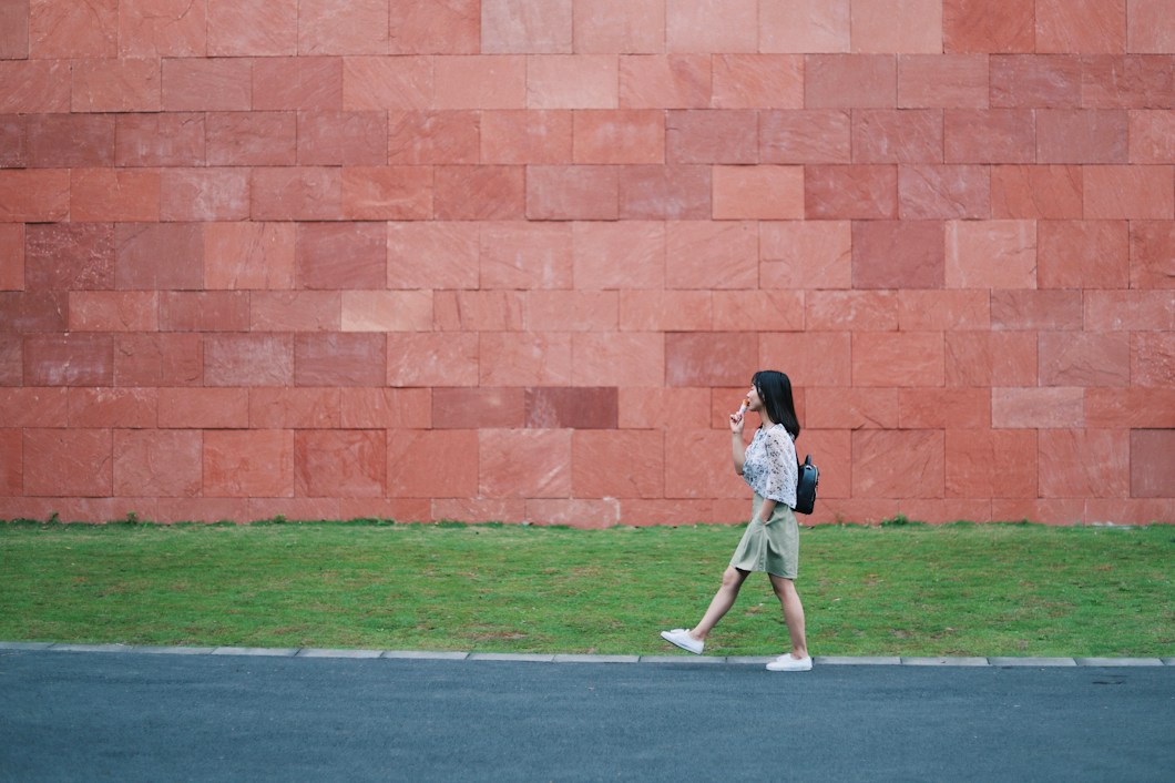Person walking alone on an open road