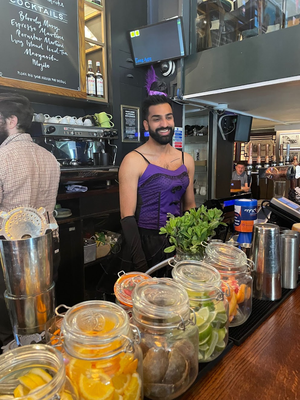 Portrait of a person in dark clothing speaking on a phone