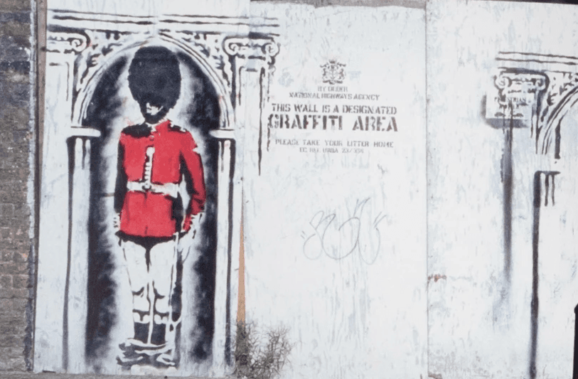 A fast black sports car races down the highway.