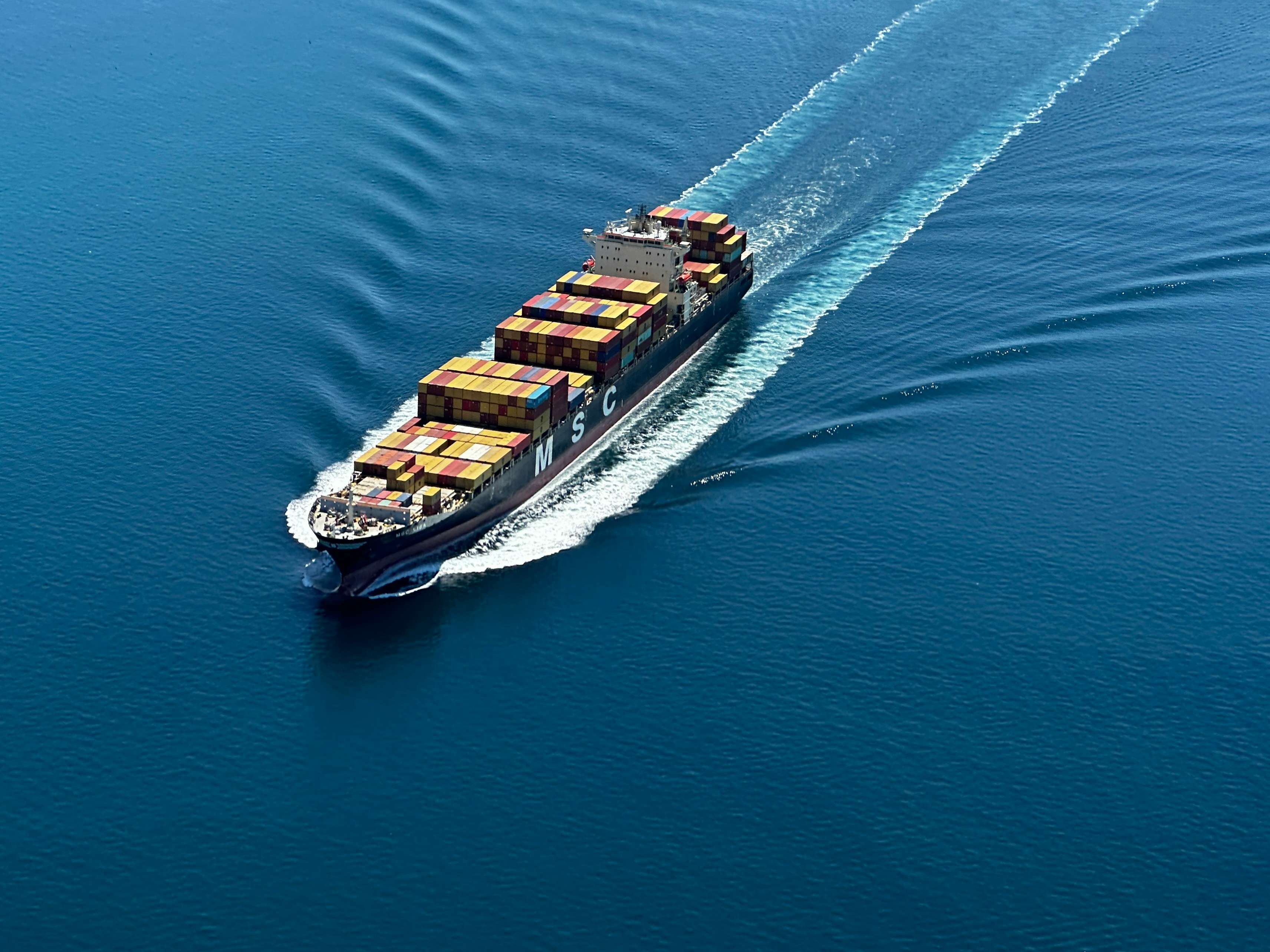a large cargo ship with lots of containers on it's back