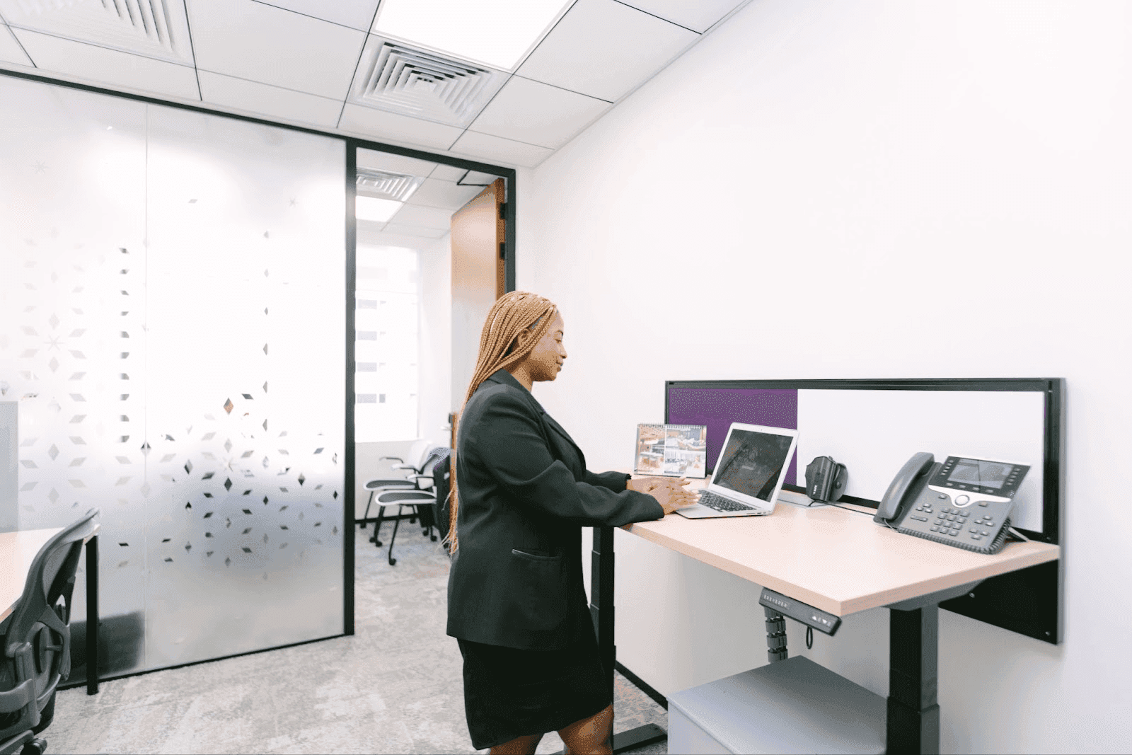 Professional woman working in modern Dubai office while managing business banking tasks