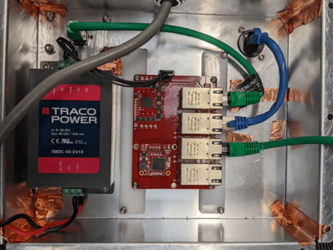 PoEBlox and DC-DC converter mounted in the shielded prototyping enclosure, sealed with copper tape