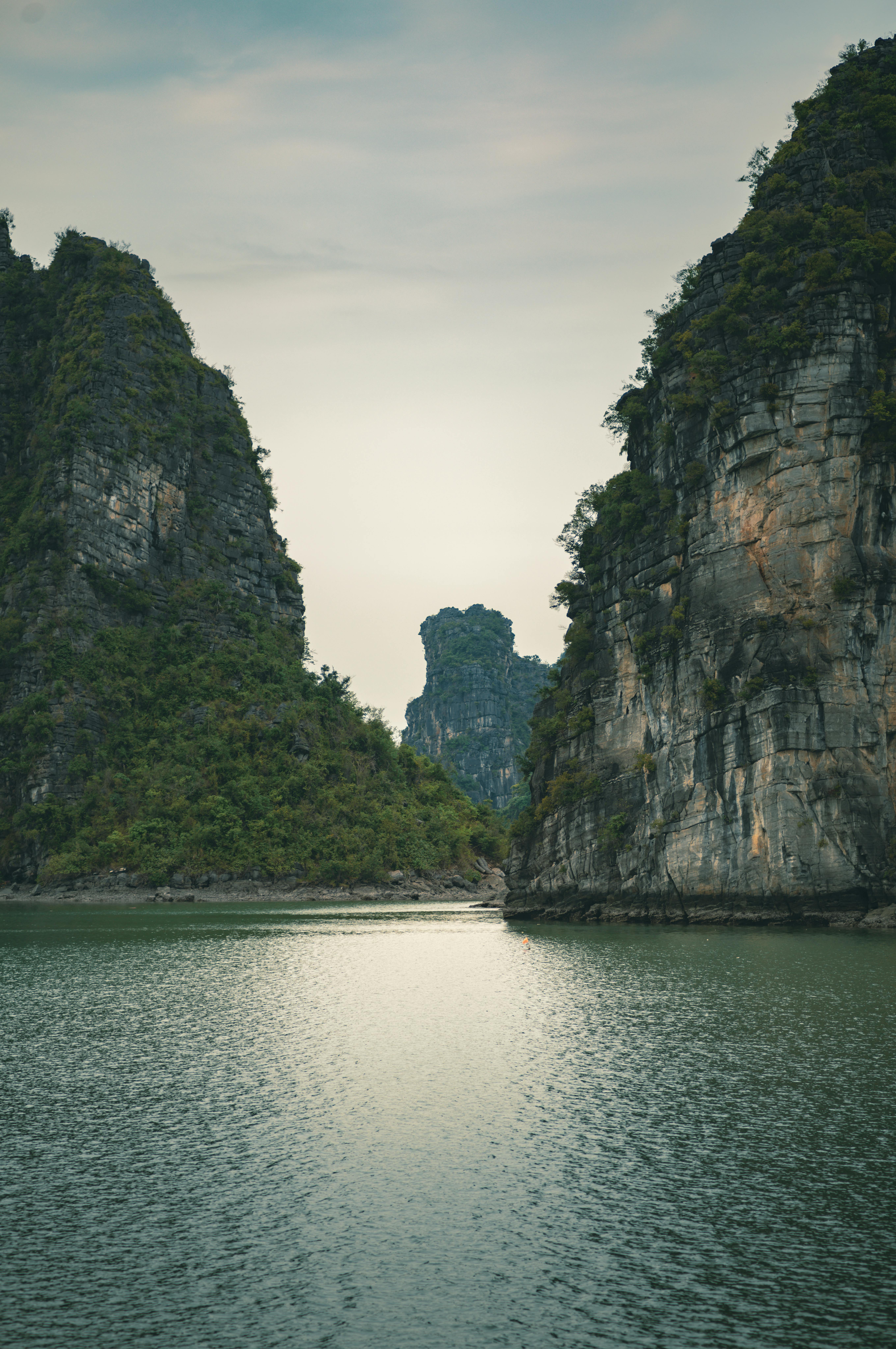 limestone karsts rising from tranquil waters, captured in Vietnam
