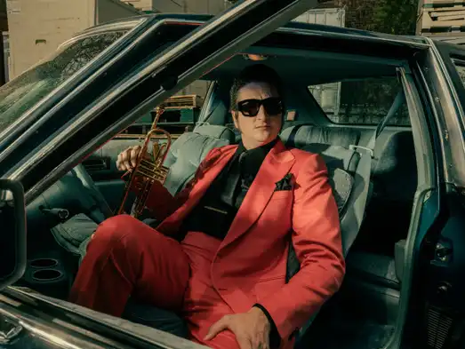 Brian Newman holding his trumpet.