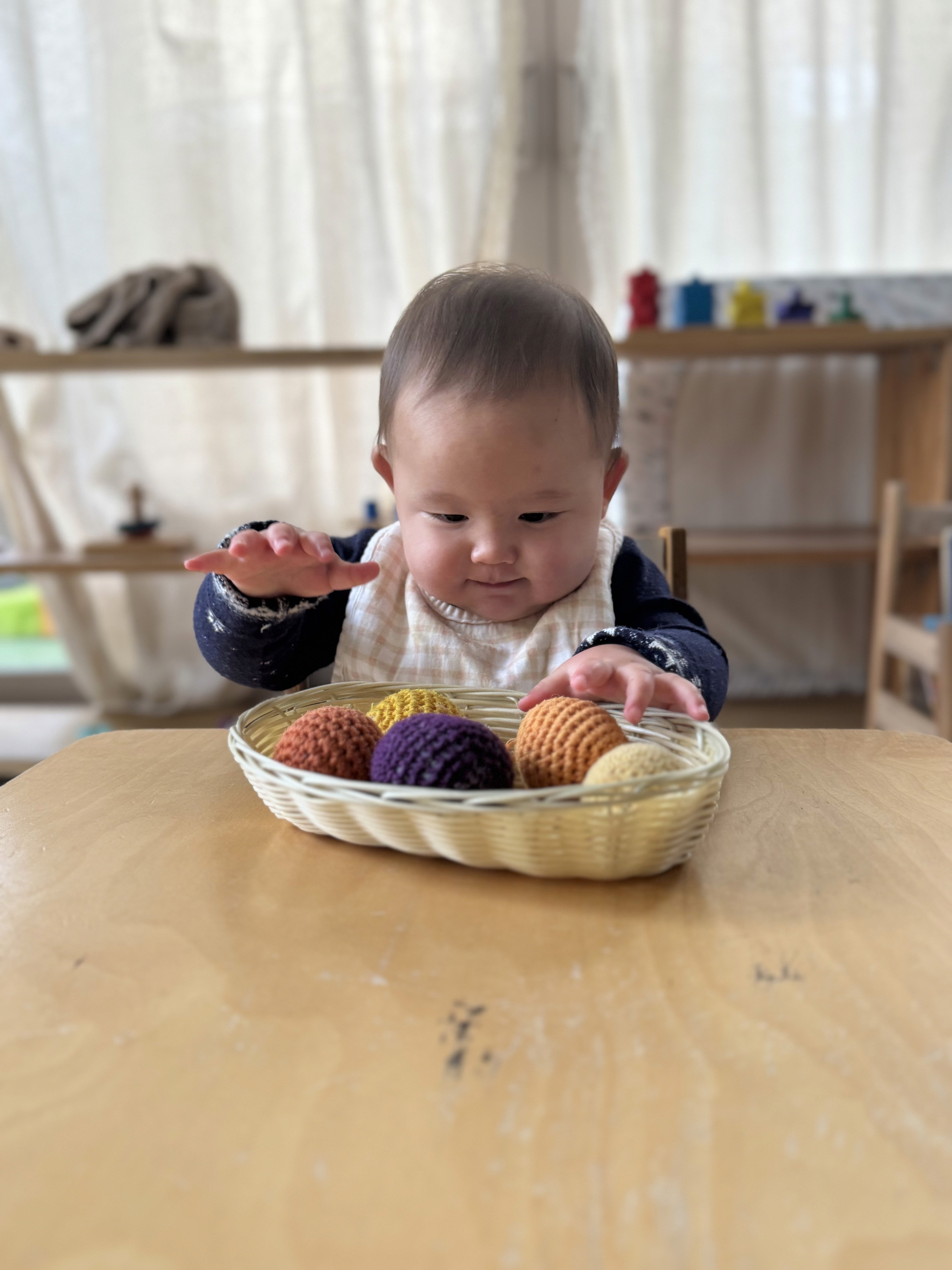 Infant exploring sensory materials in Montessori infant toddler program in Irvine CA
