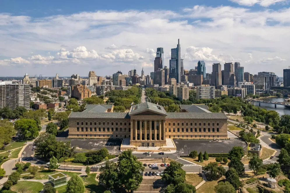 a large building with a city in the background