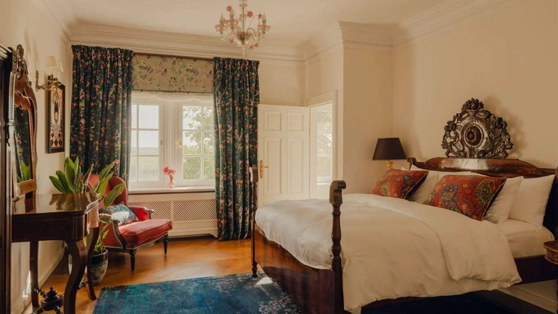 a palace bedroom with a large continental bed