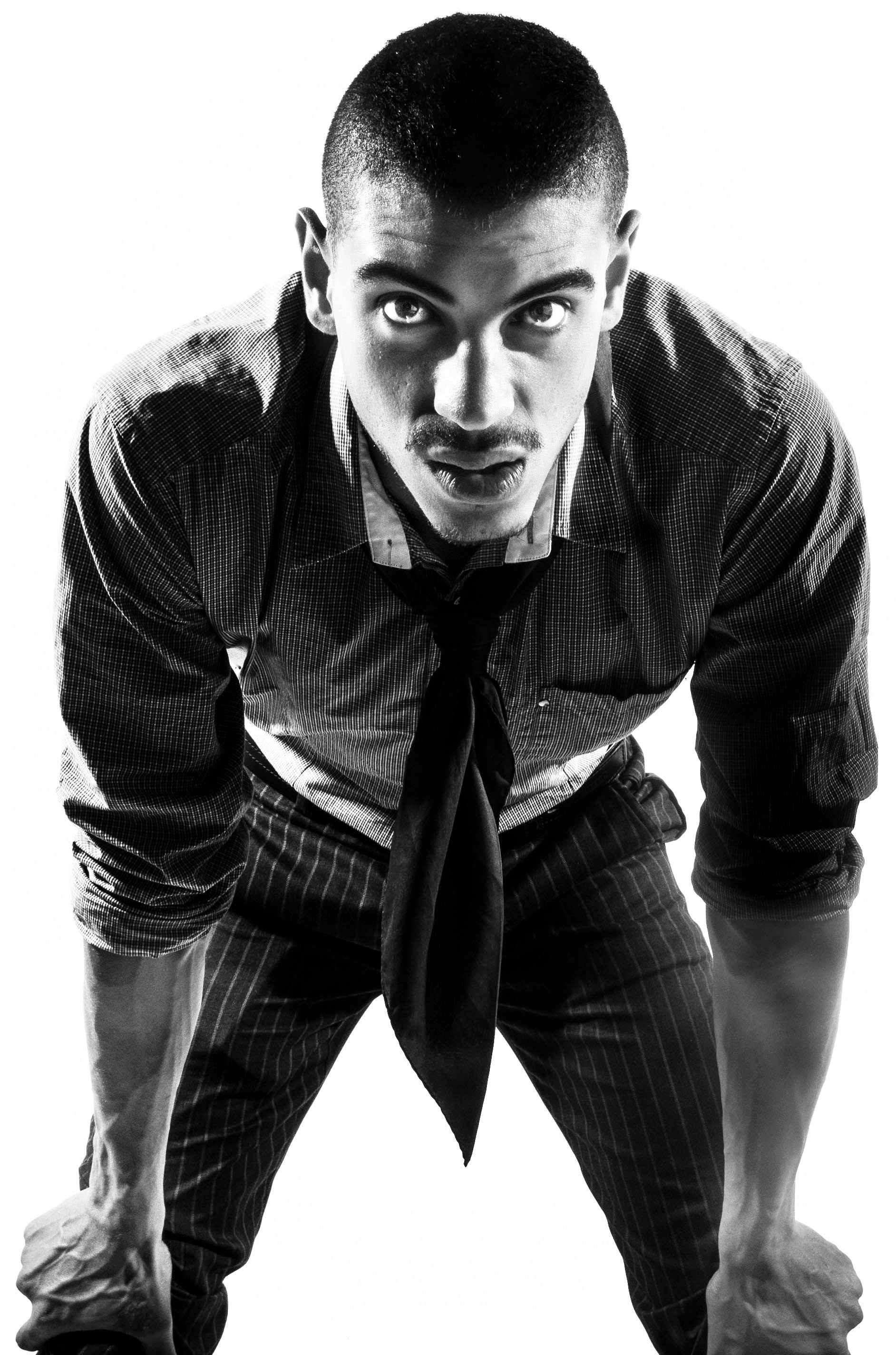 Studio portrait in black and white with a focus on sharp facial detail and sophisticated styling, utilizing soft-box lighting to create clean, high-fashion skin tones.