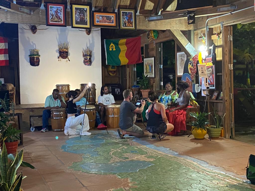 Film crew and community members gathered at a cultural space in Puerto Rico