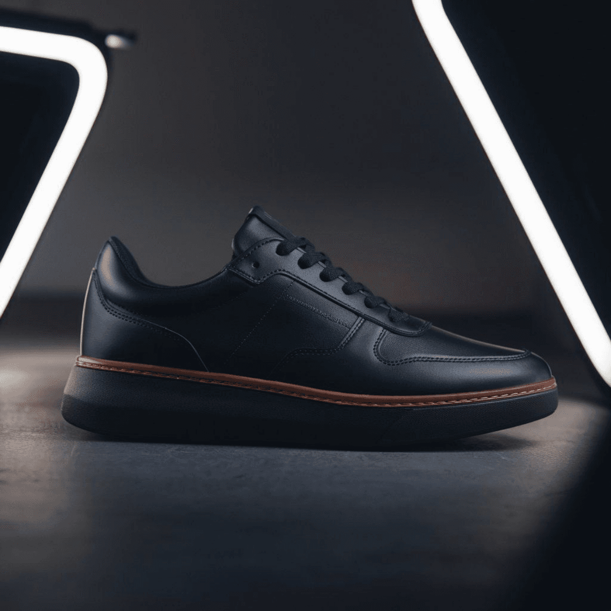 Black Corbell men's casual sneaker with leather upper and brown trim on sole.