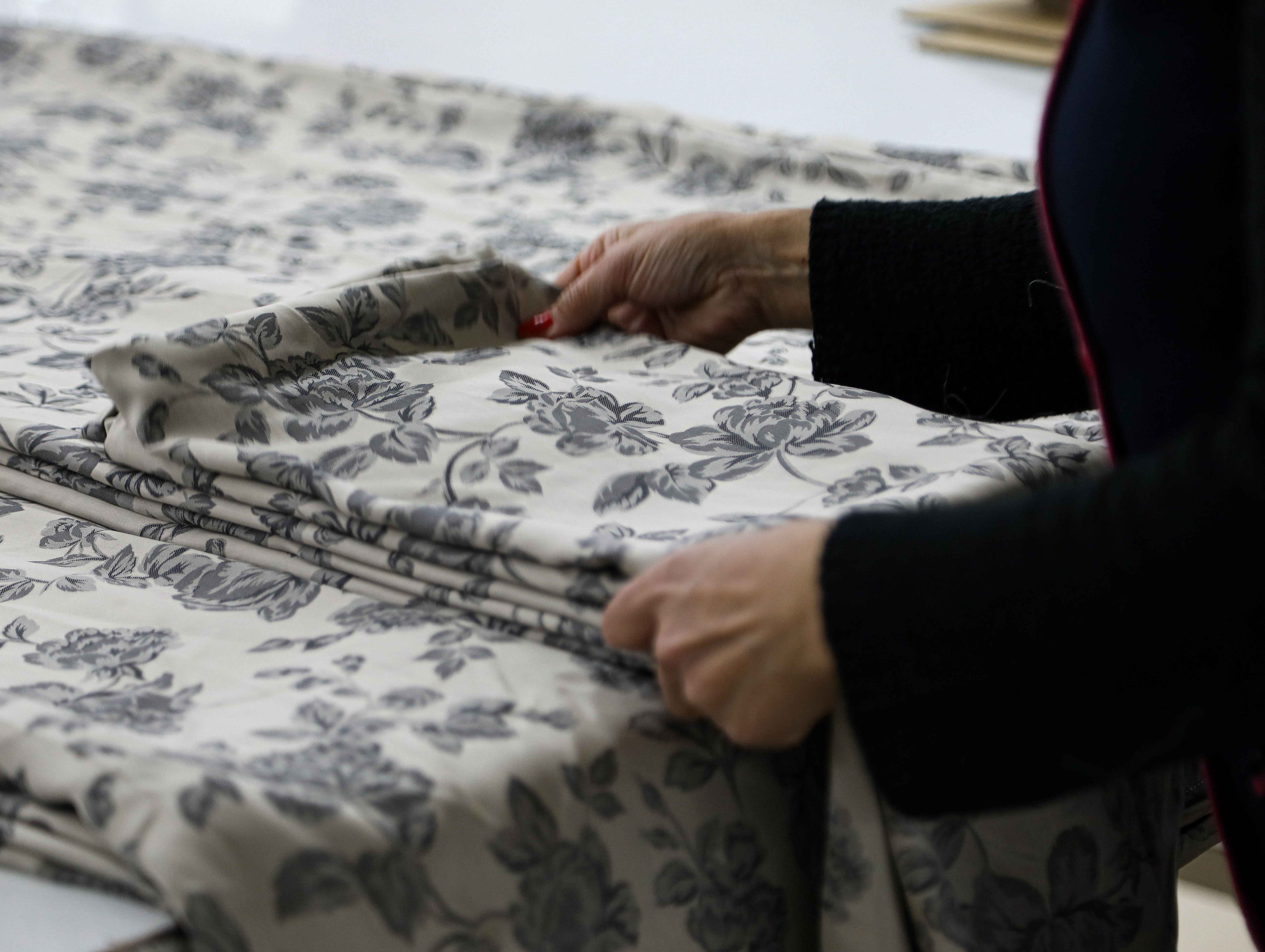 A scene of two ladies unfolding a floor mat