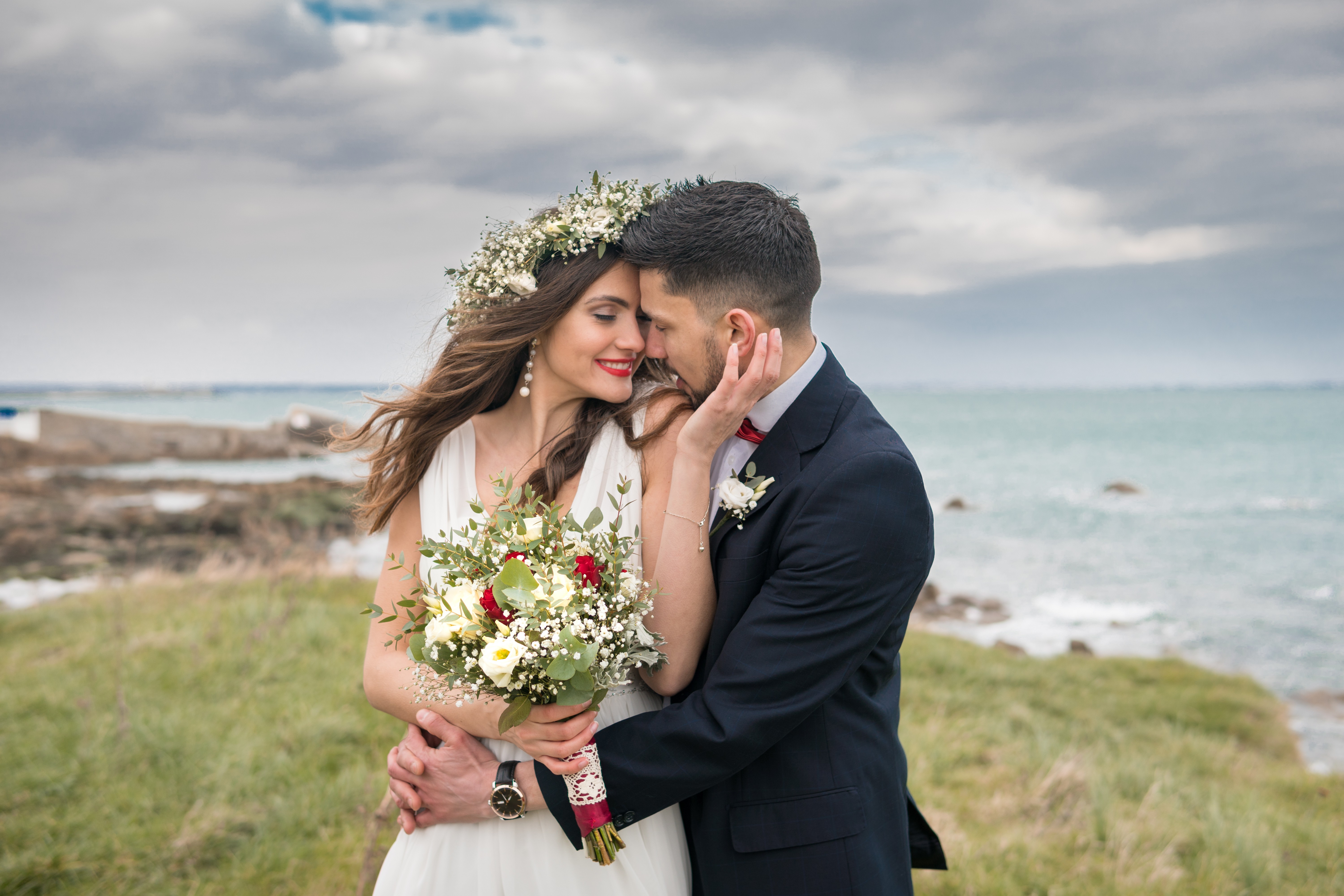 Wedding couple embracing beside the sea