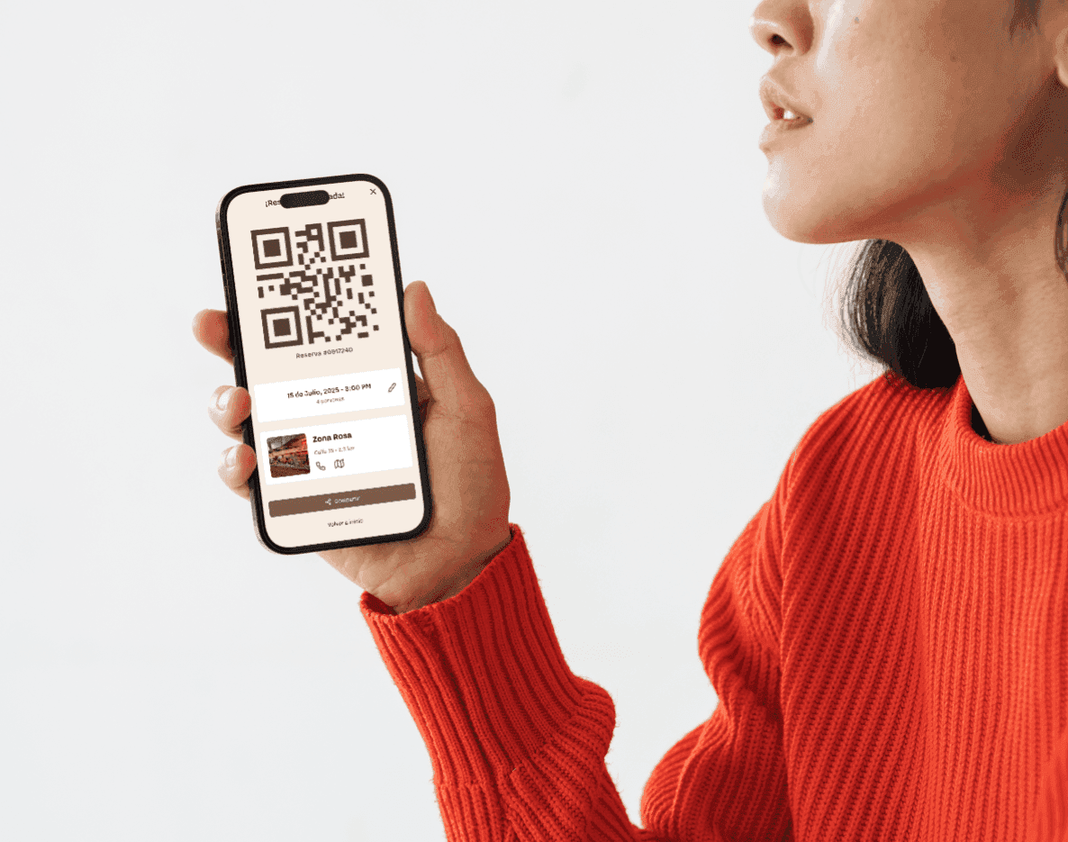 Sculptural chrome vase with a single red flower on white—minimal modern décor still life.