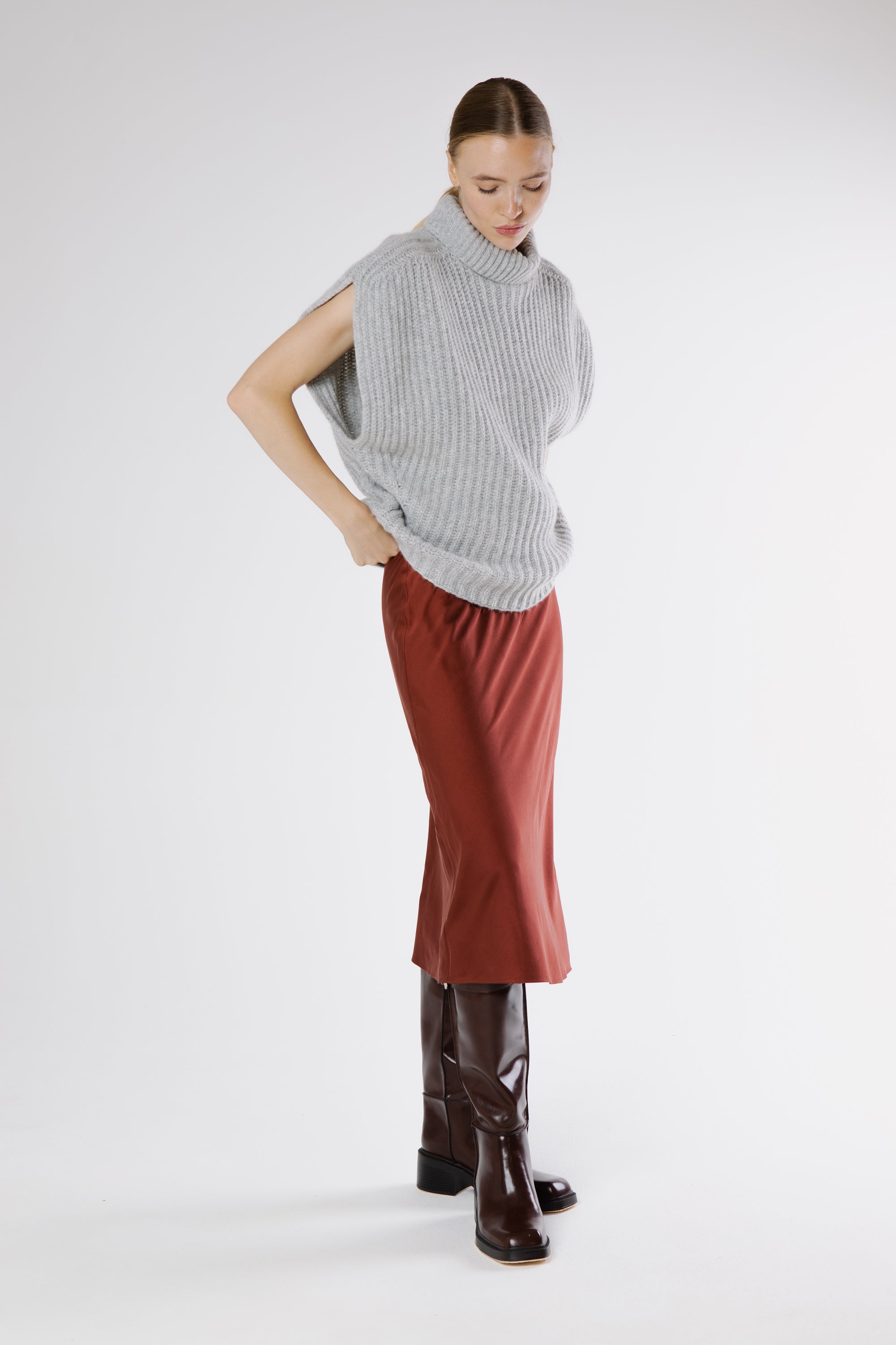 Side view of the Midi Heavy Silk Satin Skirt in Russet showing the elegant drape of the silk fabric.