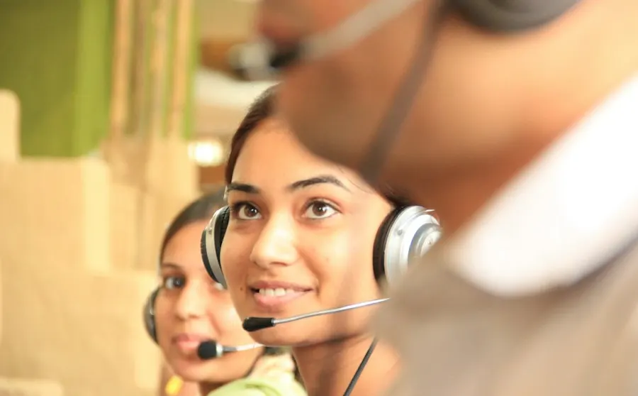 Support agents with headsets at their desks