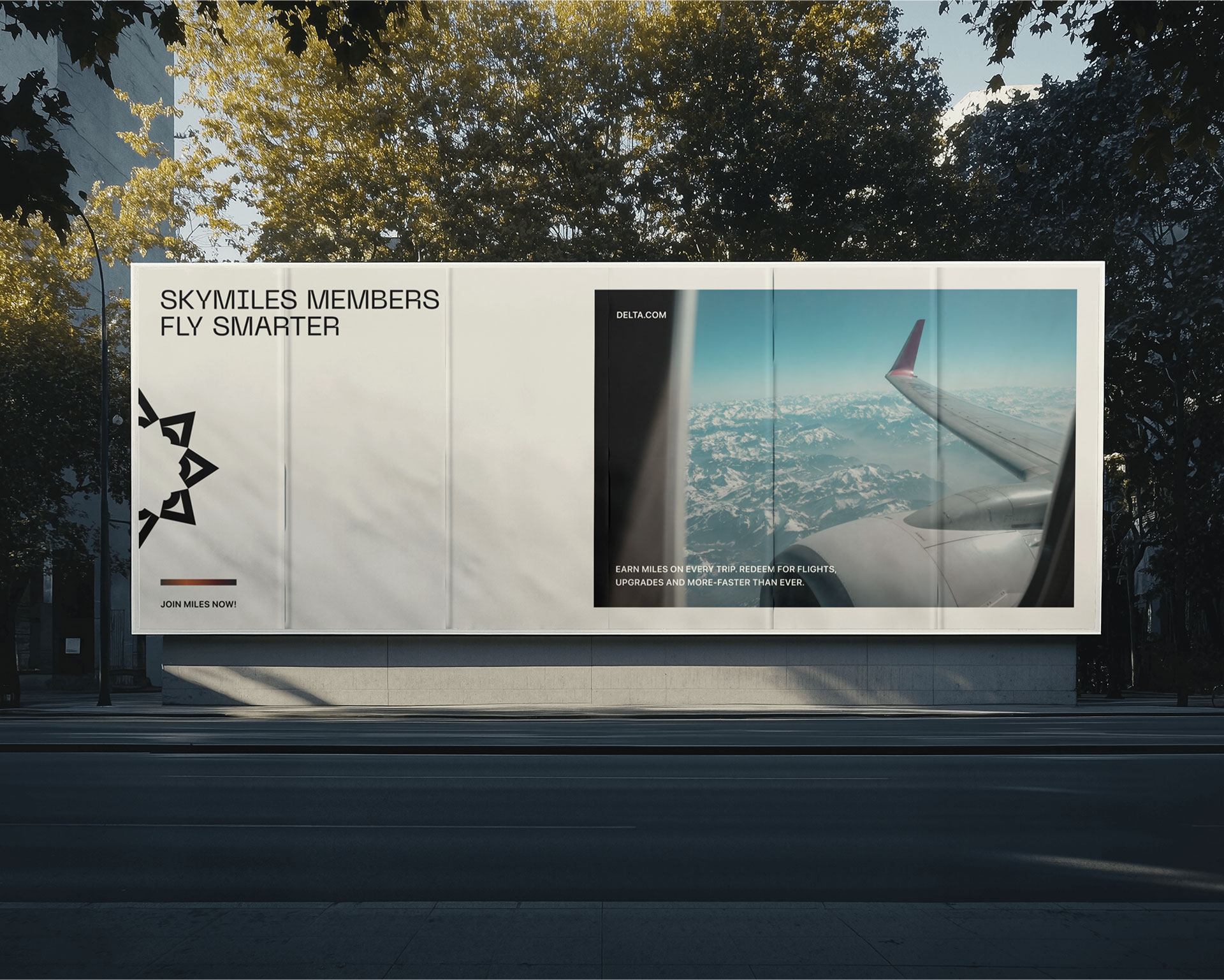 A large outdoor advertisement showcases a travel-themed poster with an airplane wing flying over snow-capped mountains, accompanied by the caption "SkyMiles Members Fly Smarter" against a backdrop of urban greenery.