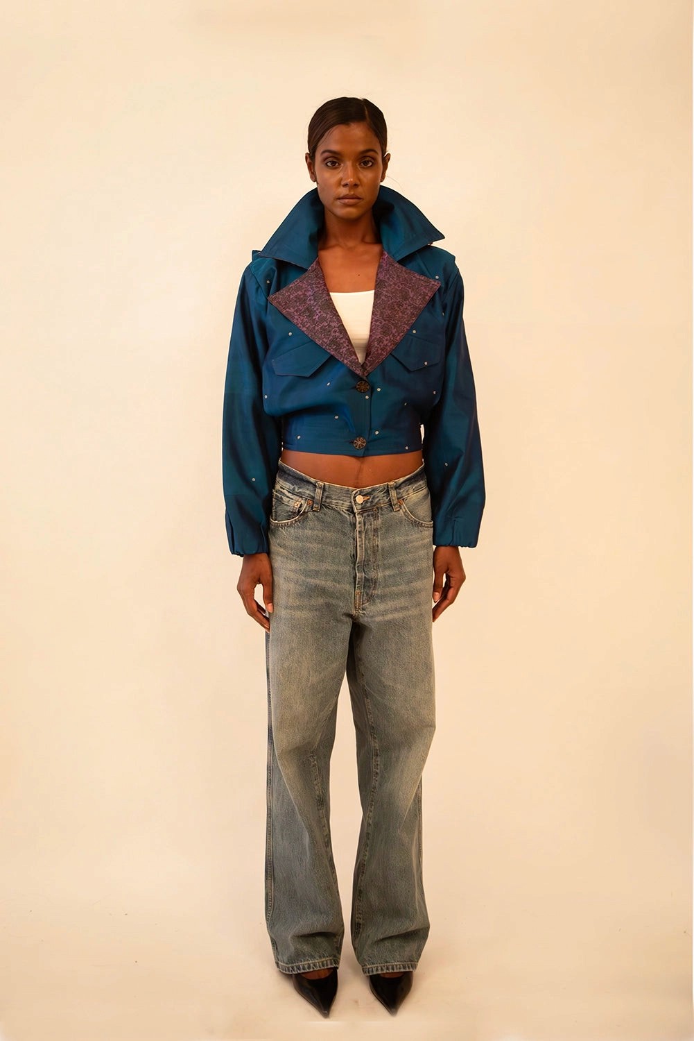 AMBR is our one-of-a-kind cropped two-toned silk brocade&nbsp; bomber jacket, handcrafted by skilled artisans in-house using a vintage silk saris