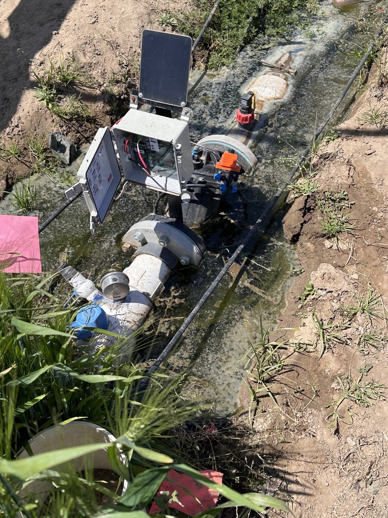 M8 automation controller submerged in water in farm field.