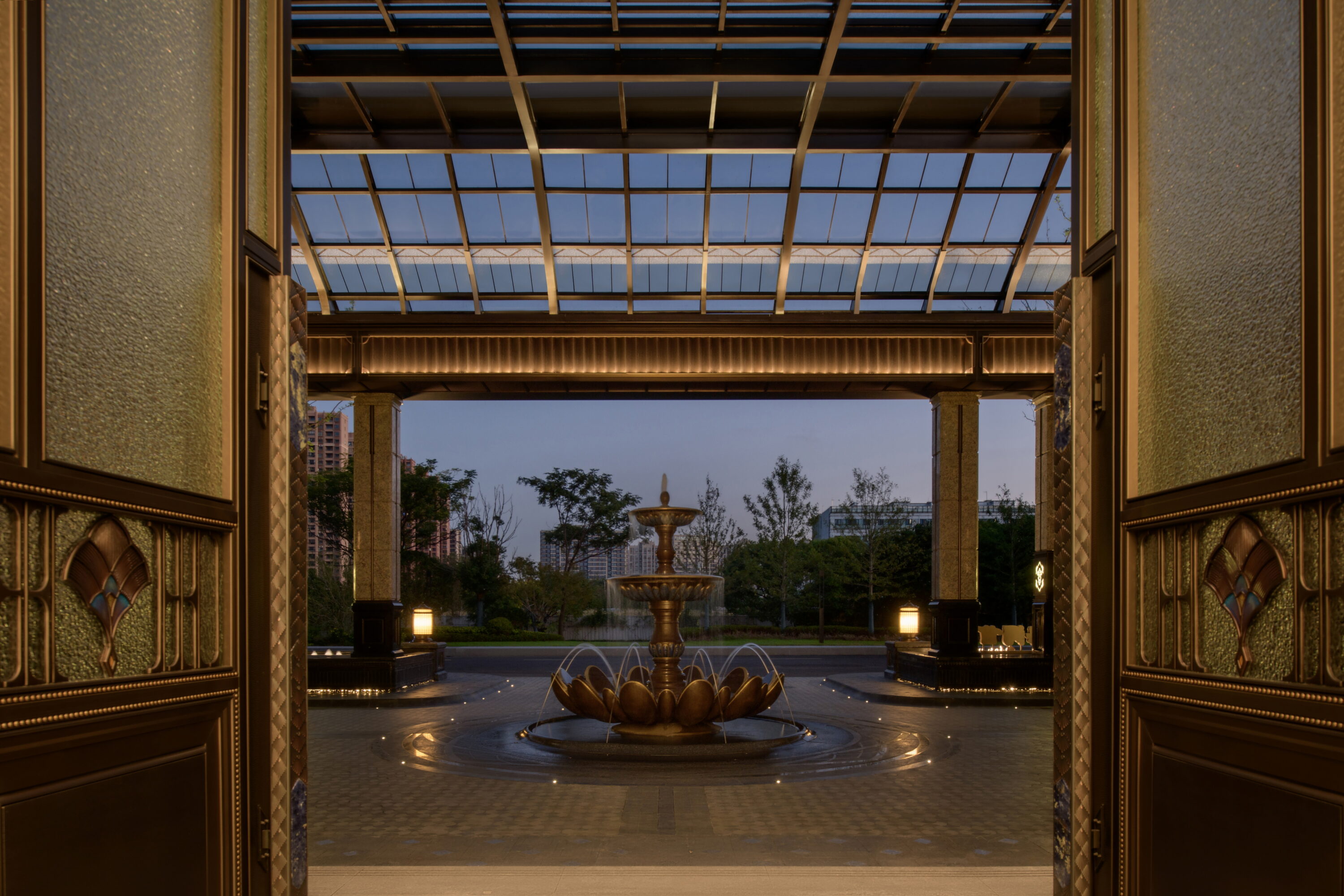 A woman observes framed black-and-white photographs in warm golden light