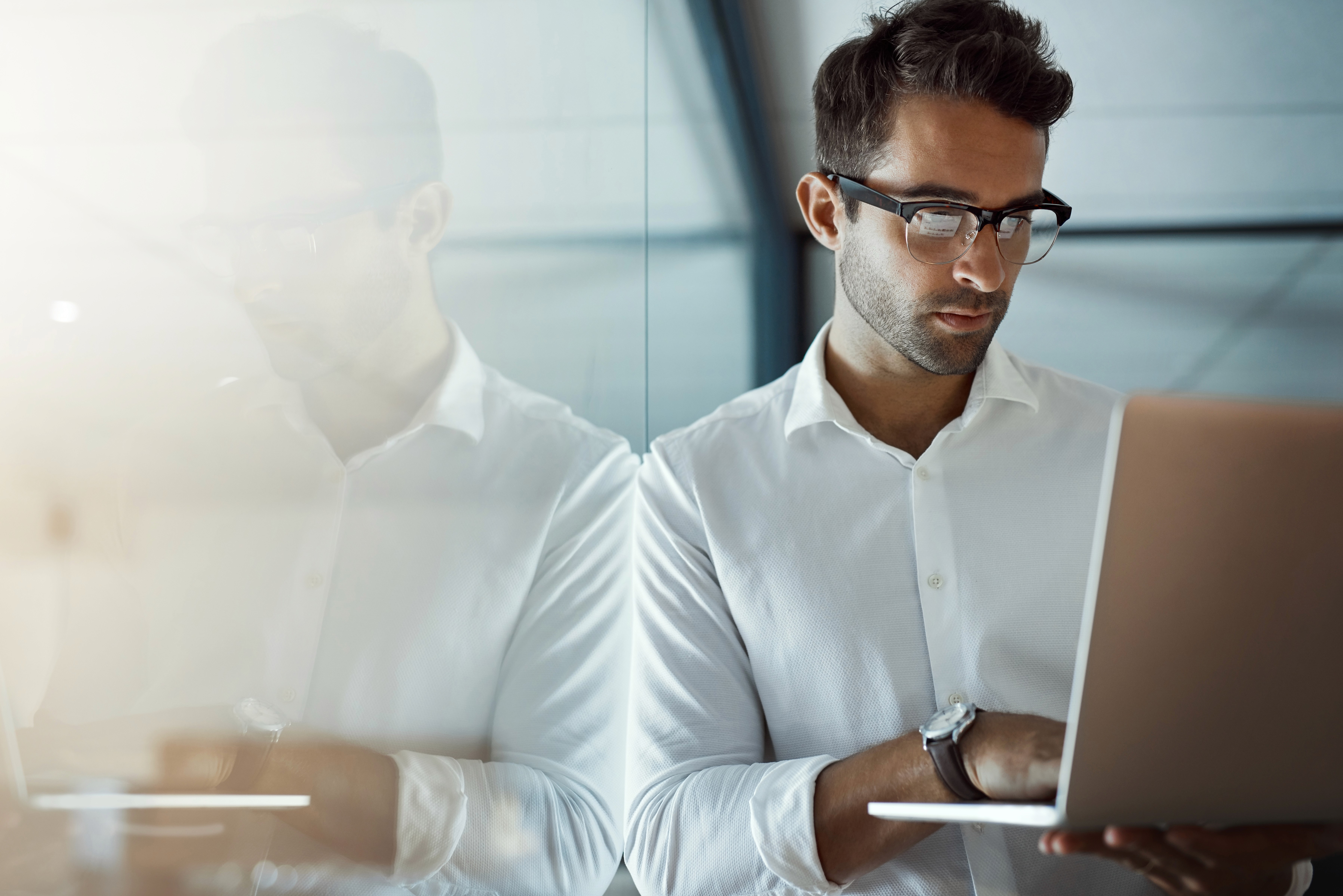 Young businessman working on his laptop in the office