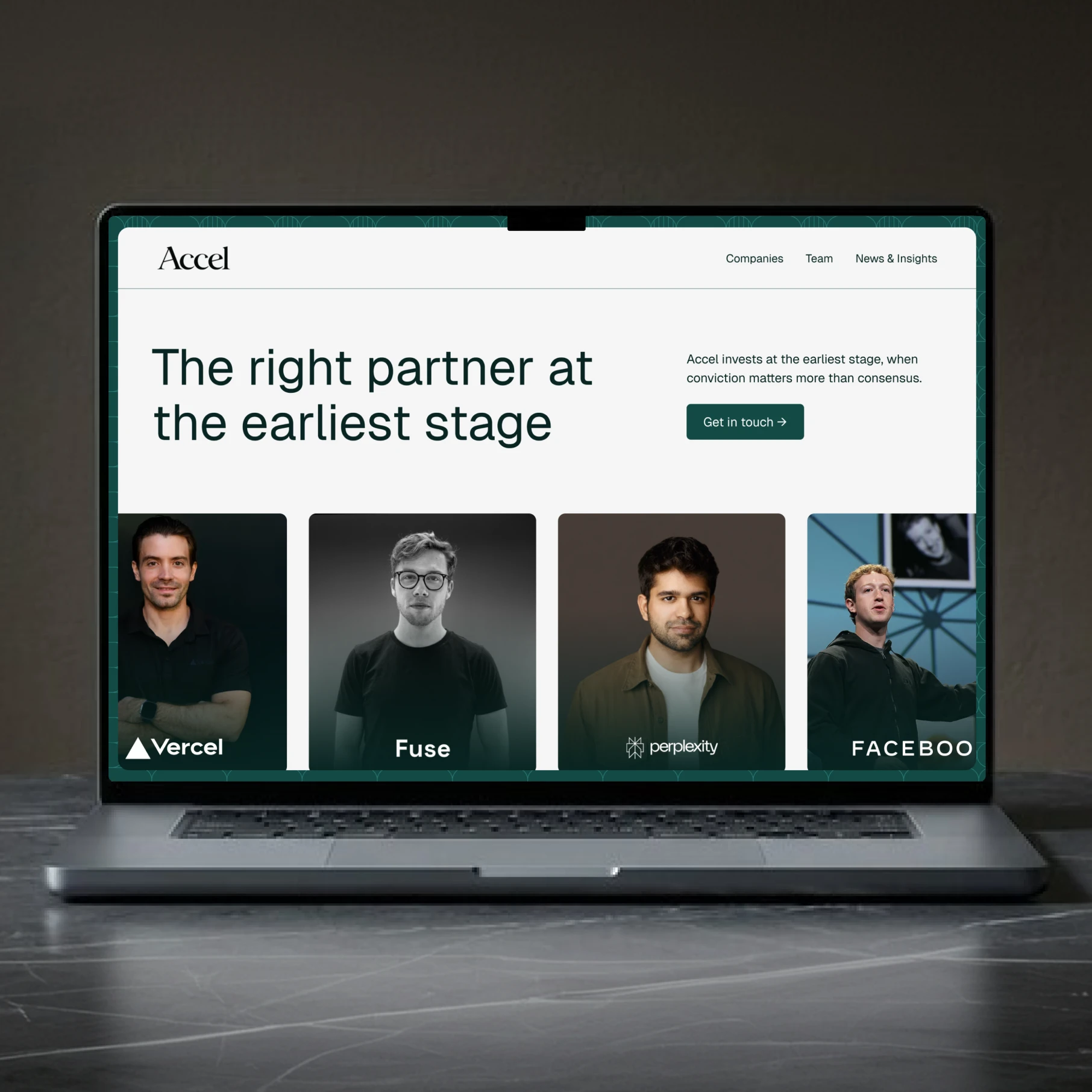 Laptop displaying Accel website with team photos