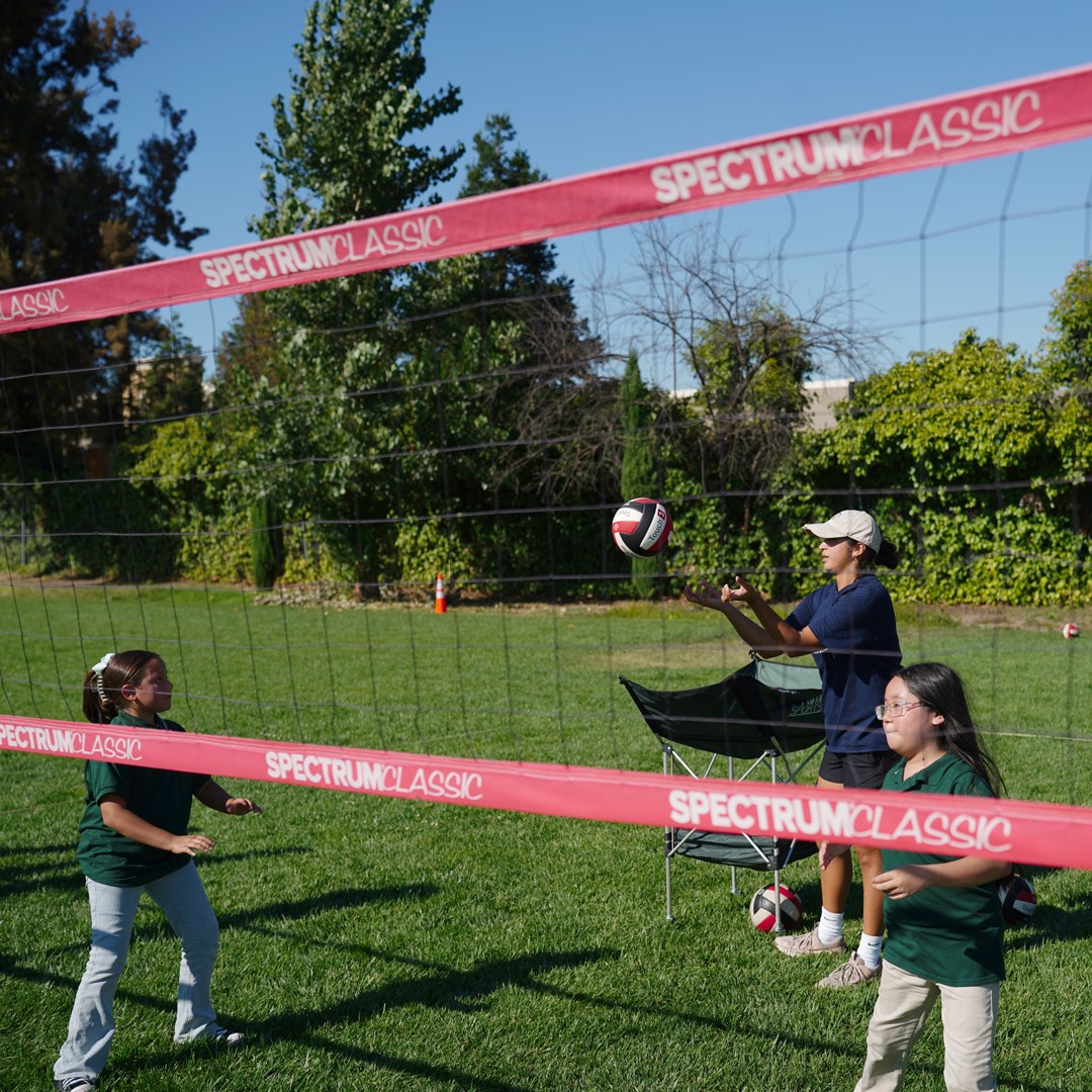 Children practicing passing and serving skills in a HOKALI youth volleyball class