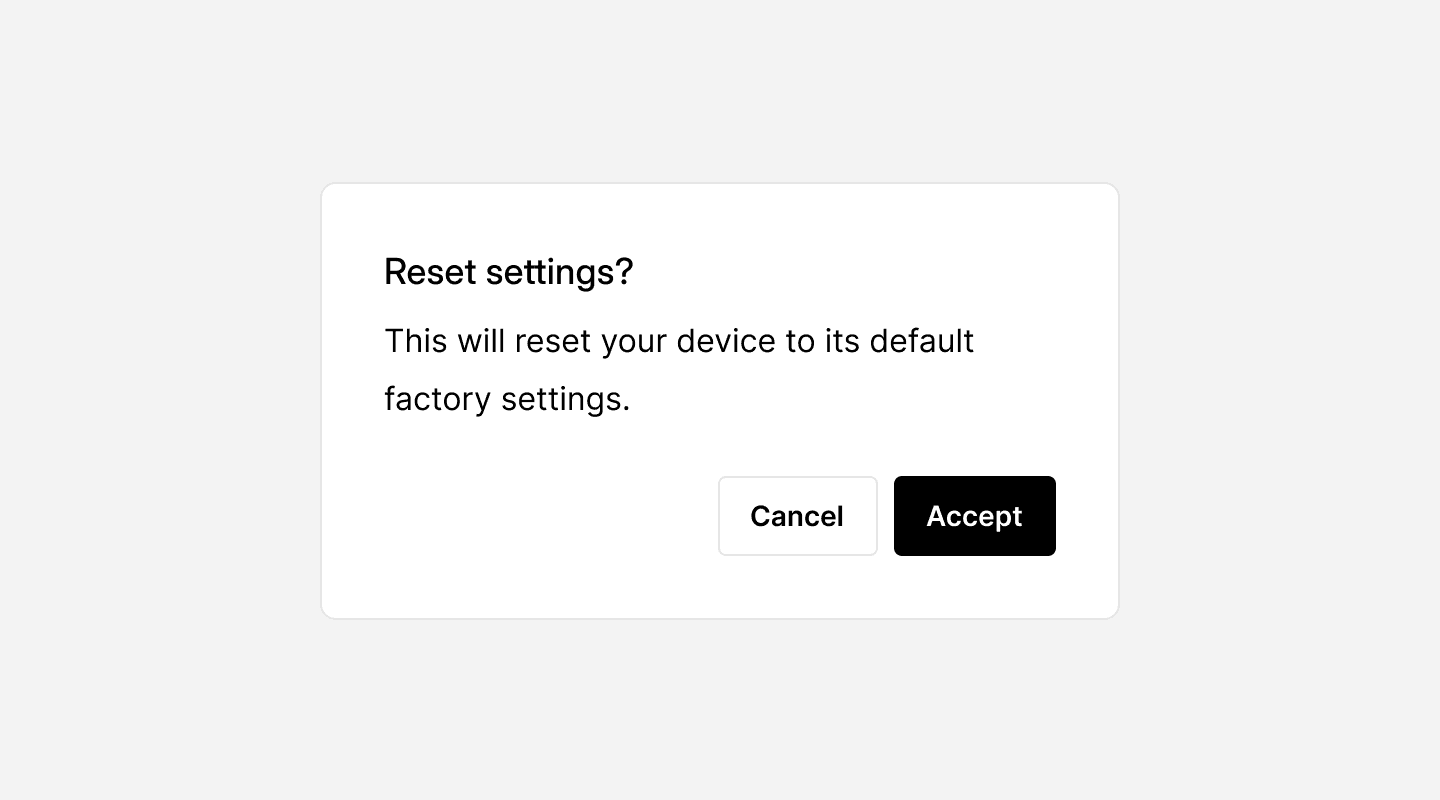 A confirmation dialog box prompting the user with “Reset settings?” followed by a message stating, “This will reset your device to its default factory settings.” Below the message, there are two buttons: “Cancel” with a white background and “Accept” with a black background. The design provides a clear decision-making interface for users before performing a potentially irreversible action.