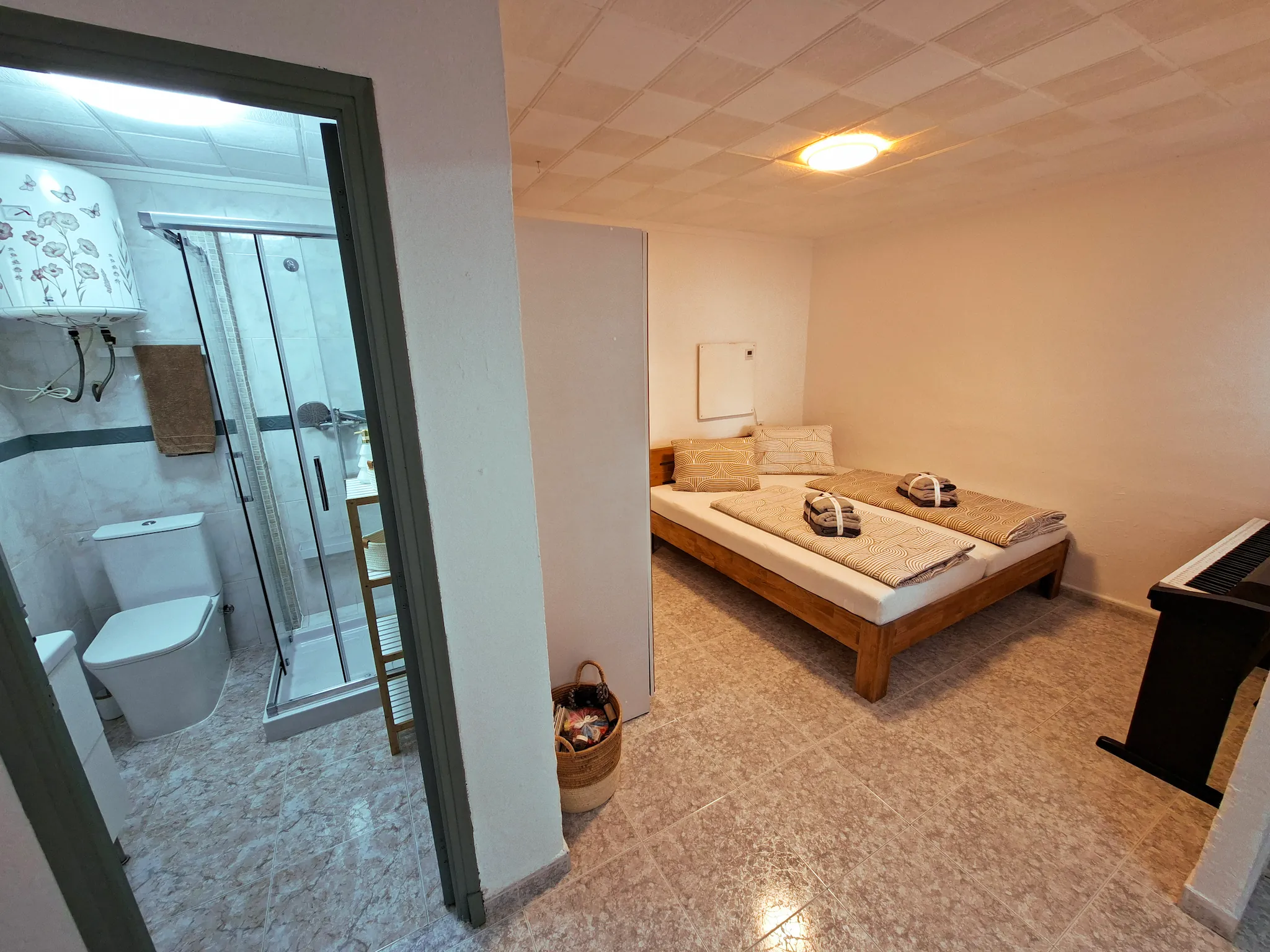 Minimalist living space with low modern furniture, large floor-to-ceiling windows, soft natural light, and an open view of a calm outdoor landscape.