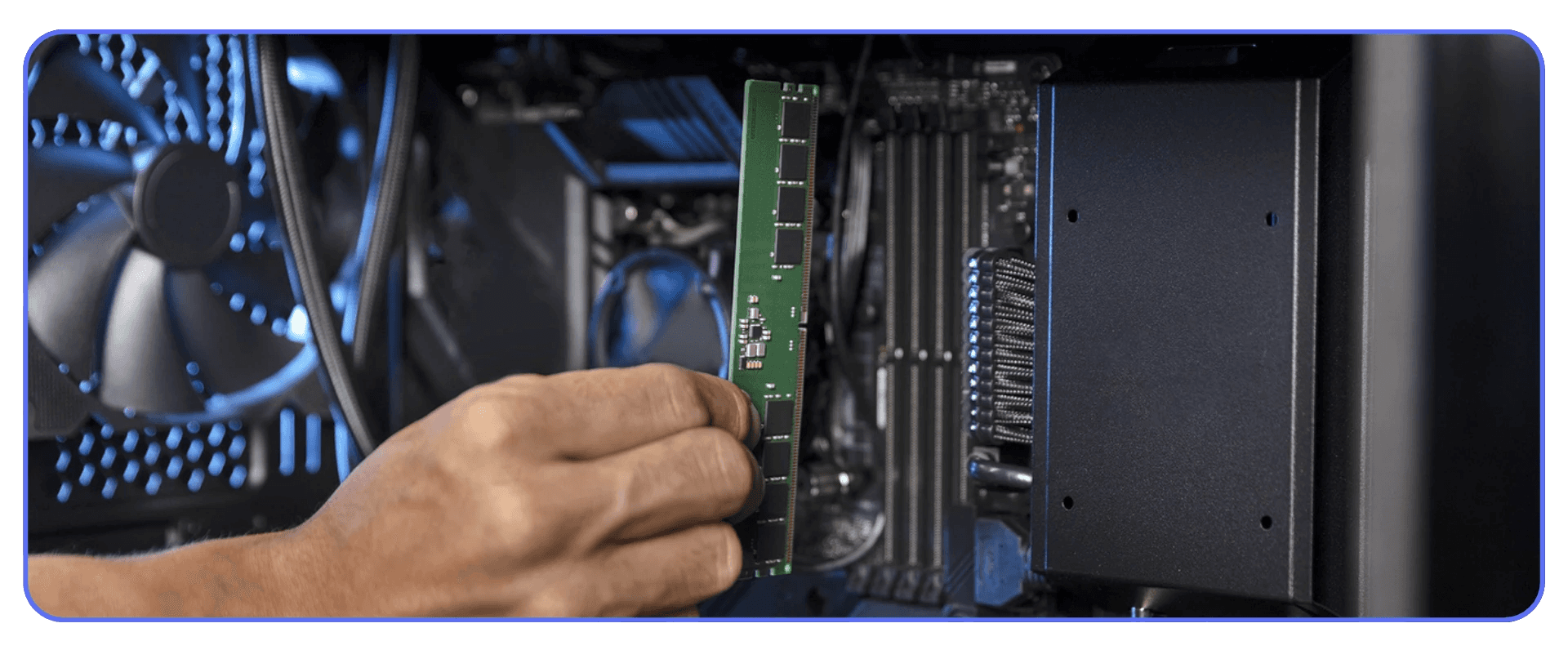 Hand installing a RAM module inside a desktop workstation.