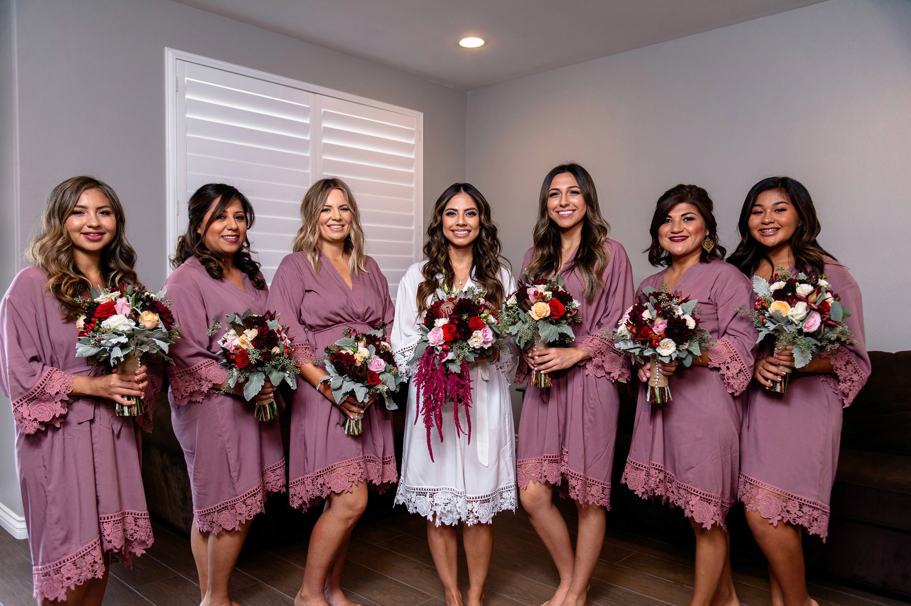 Flat lay wedding details with bouquet, rings, and sparkling bridal heels