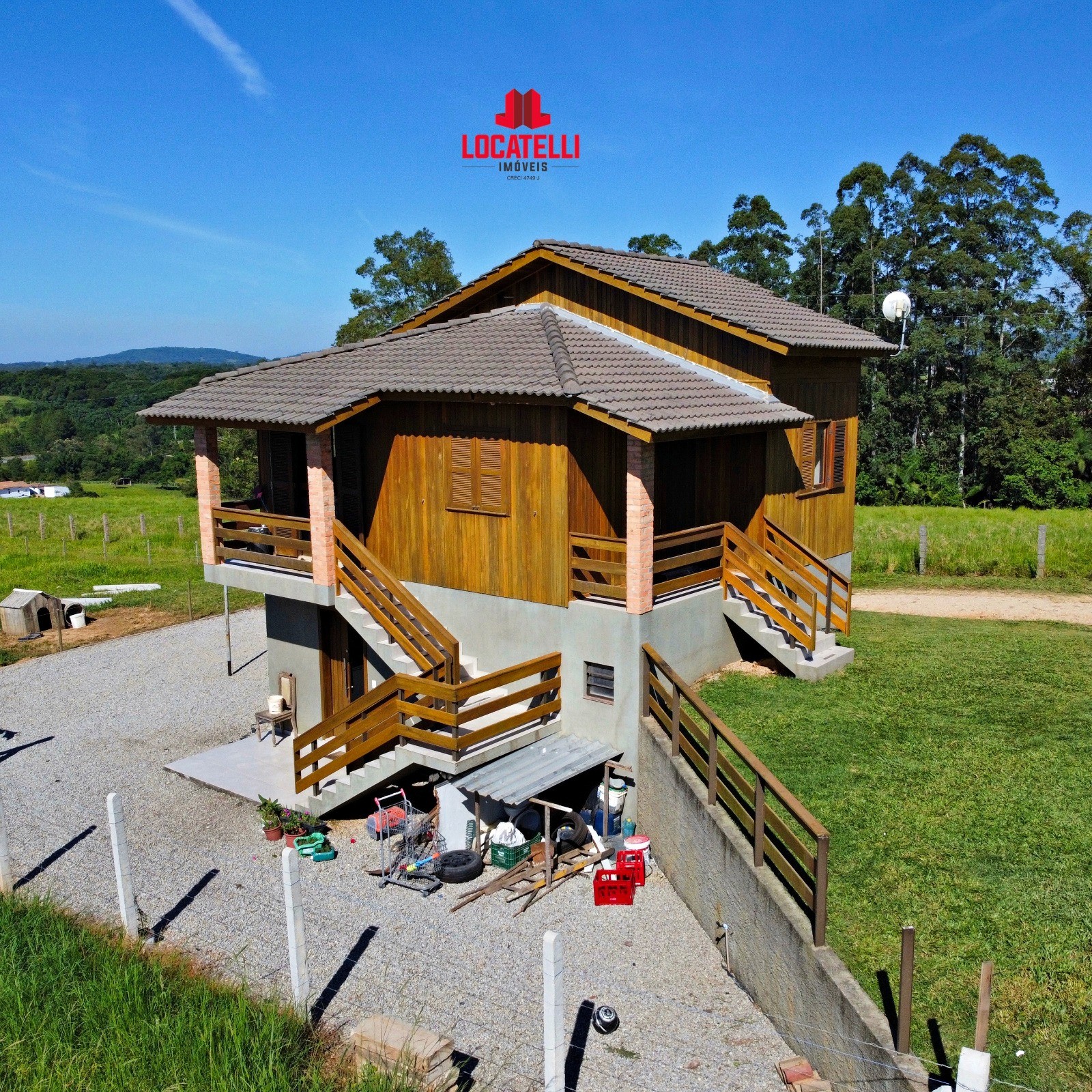 A modern brick house with a two-car garage, well-manicured lawn, and clear blue sky in the background.