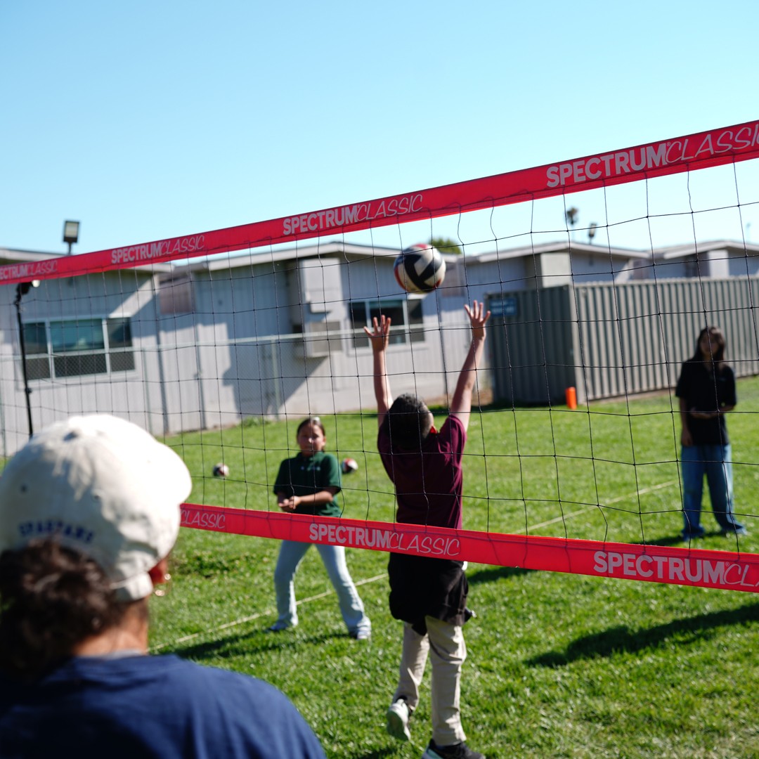 Students improving agility and teamwork during a structured volleyball activity