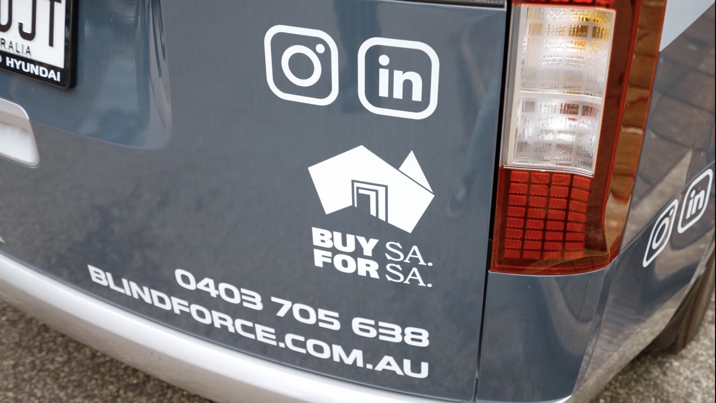 Zoomed view of Blind Force van highlighting ‘Buy for SA’ support local message