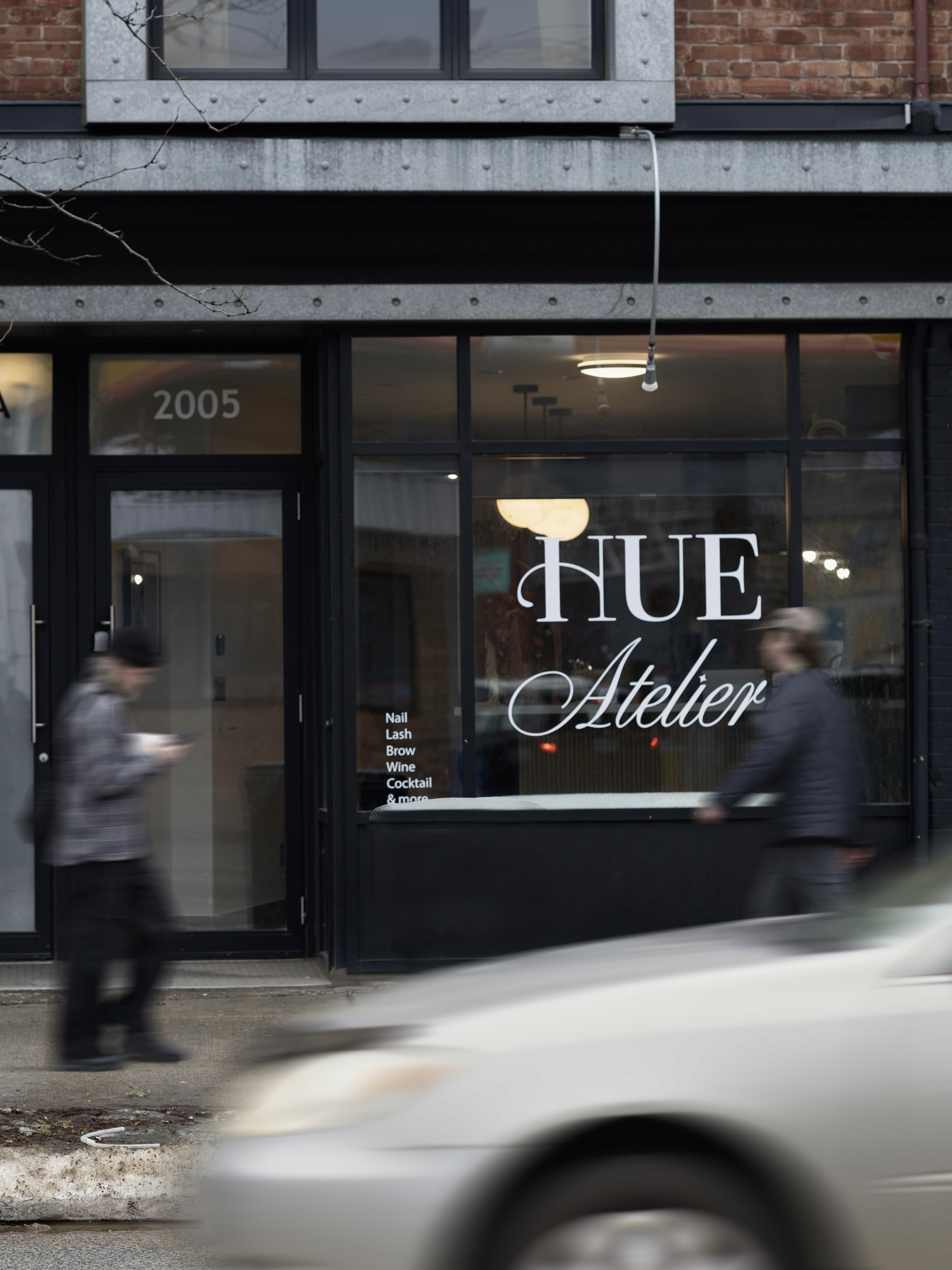 A luxurious indoor pool area with a panoramic view of a city at sunset. Comfortable lounge beds with soft fabrics surround the pool, while warm ambient lighting enhances the sophisticated atmosphere. The space combines modern elegance with a tranquil vibe.