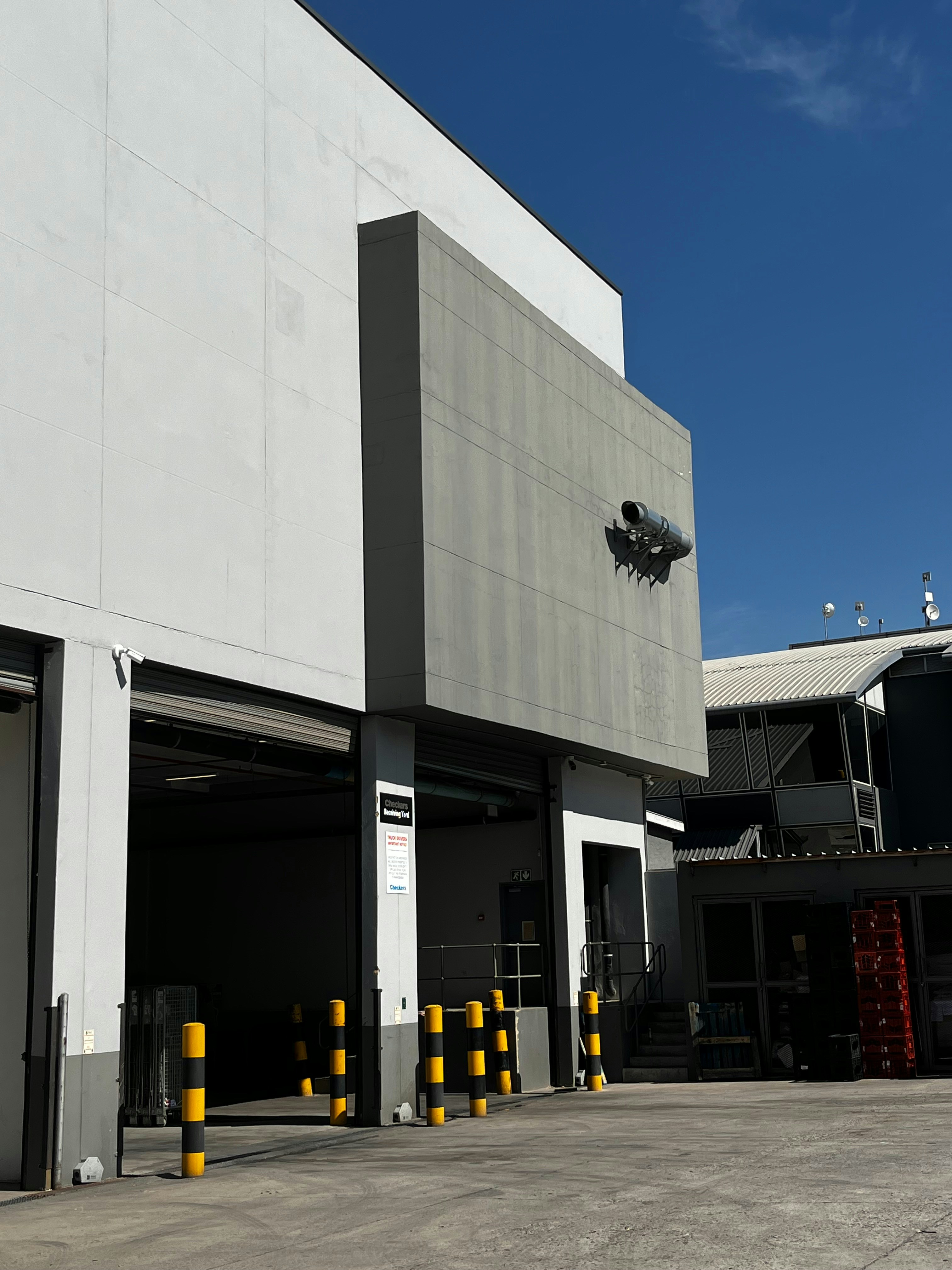 Modern industrial building exterior with loading docks.
