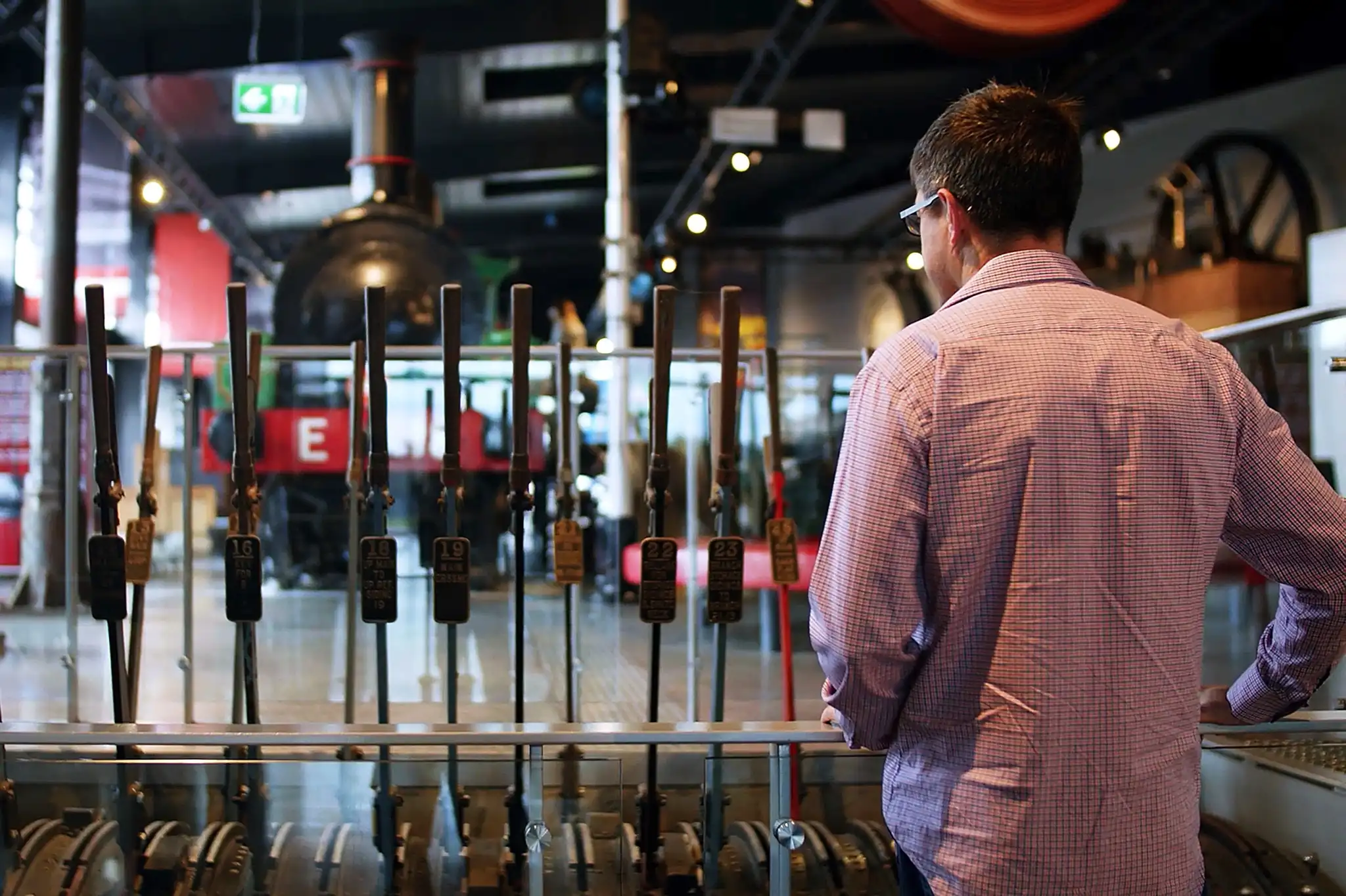 A man inspects the lever frames on display at the NSW Rail Museum.