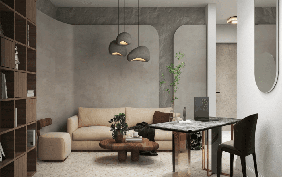 Smiling young man with short hair poses against a dark background, wearing a green button-up shirt.